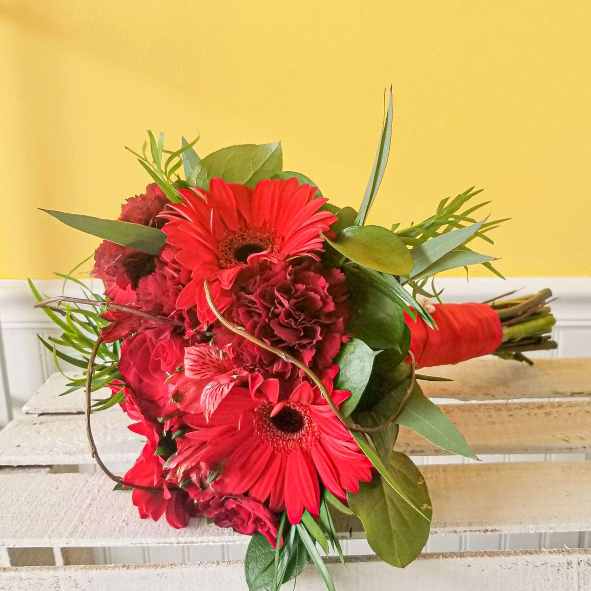 Handheld red prom bouquet with mixed flowers.
Actual Bouquets will vary with particular