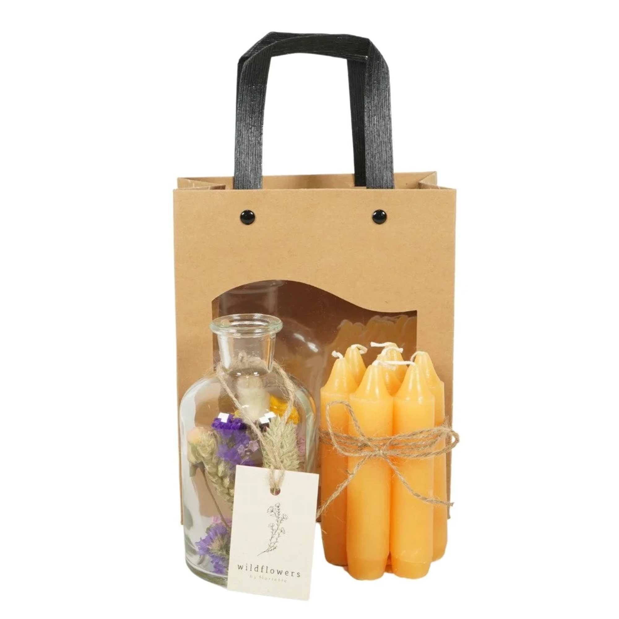 Gift bag with a glass bottle of dried flowers and a bundle of orange candles