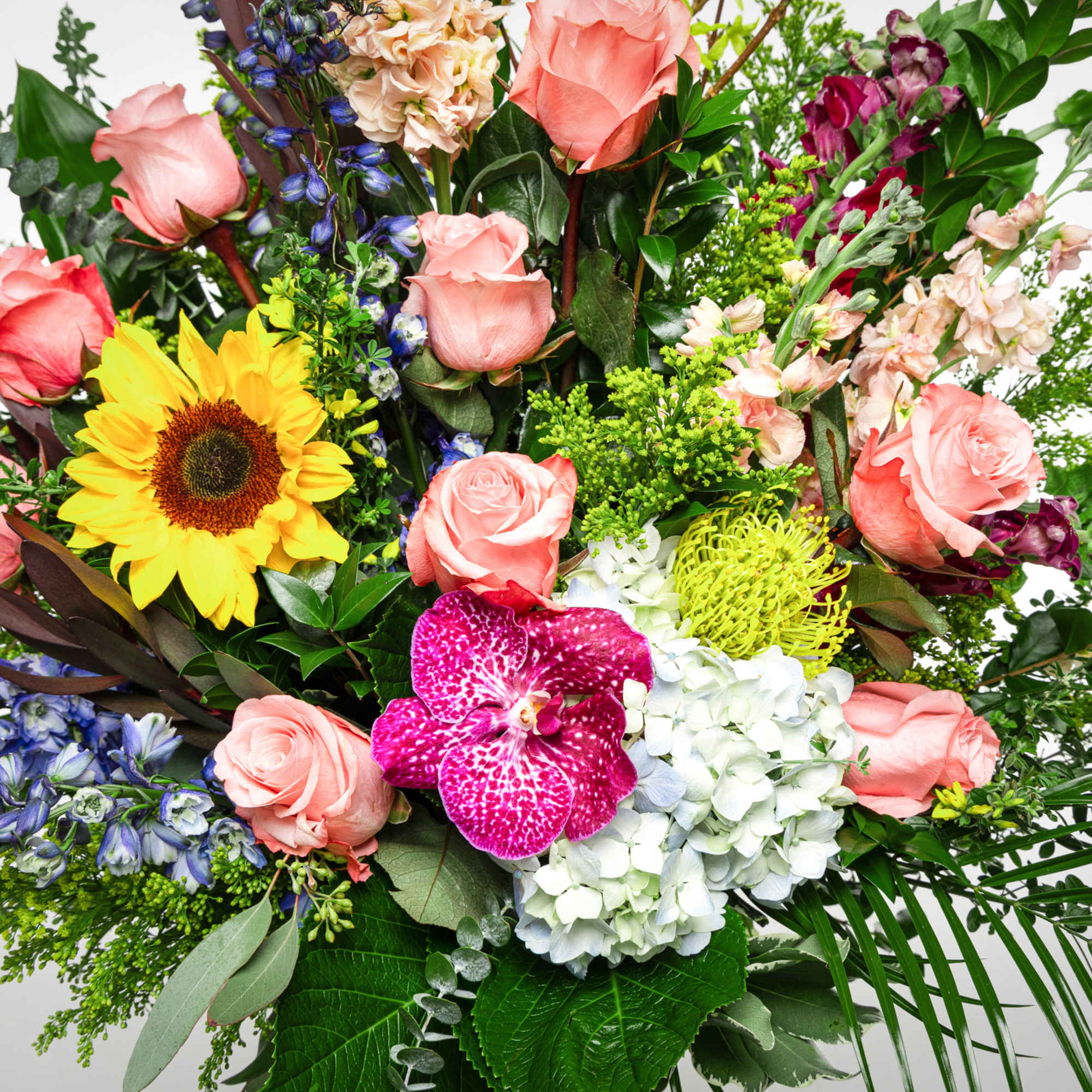 Mixed bouquet with roses, sunflower, orchids, and hydrangea