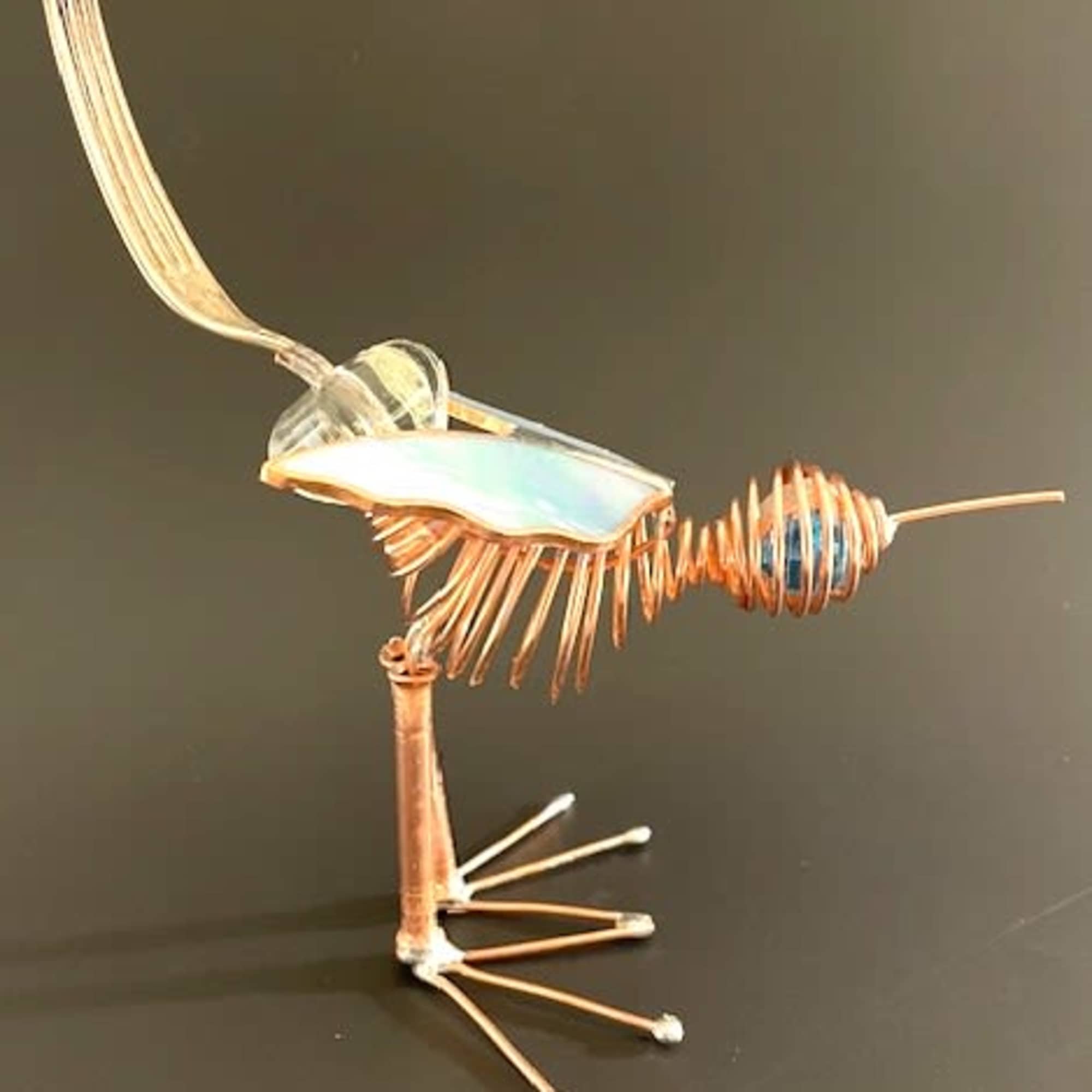 A whimsical copper-wire bird sculpture that doubles as a delightful decorative accent-perfect