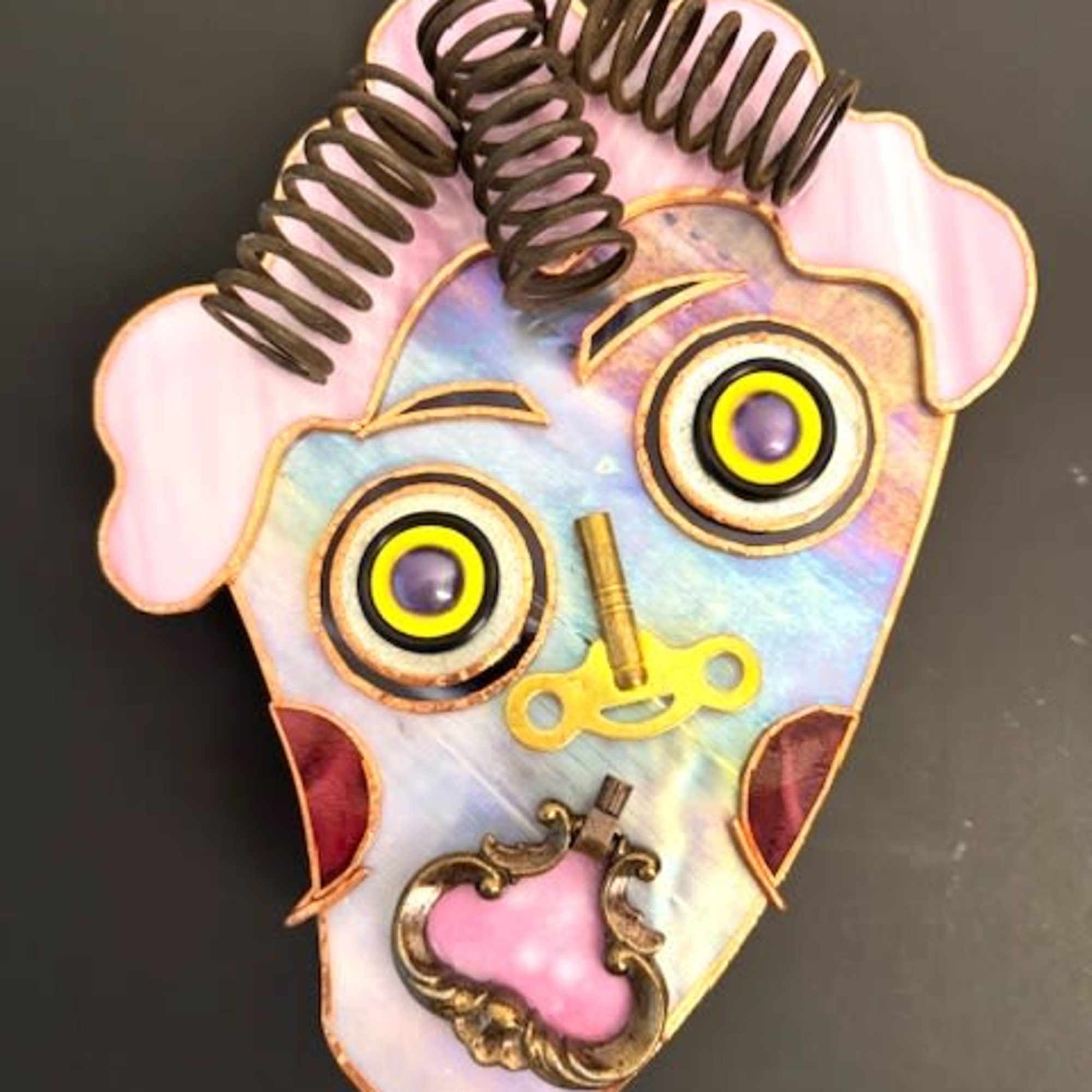 A quirky stained-glass face mask that reads like wearable folk art -