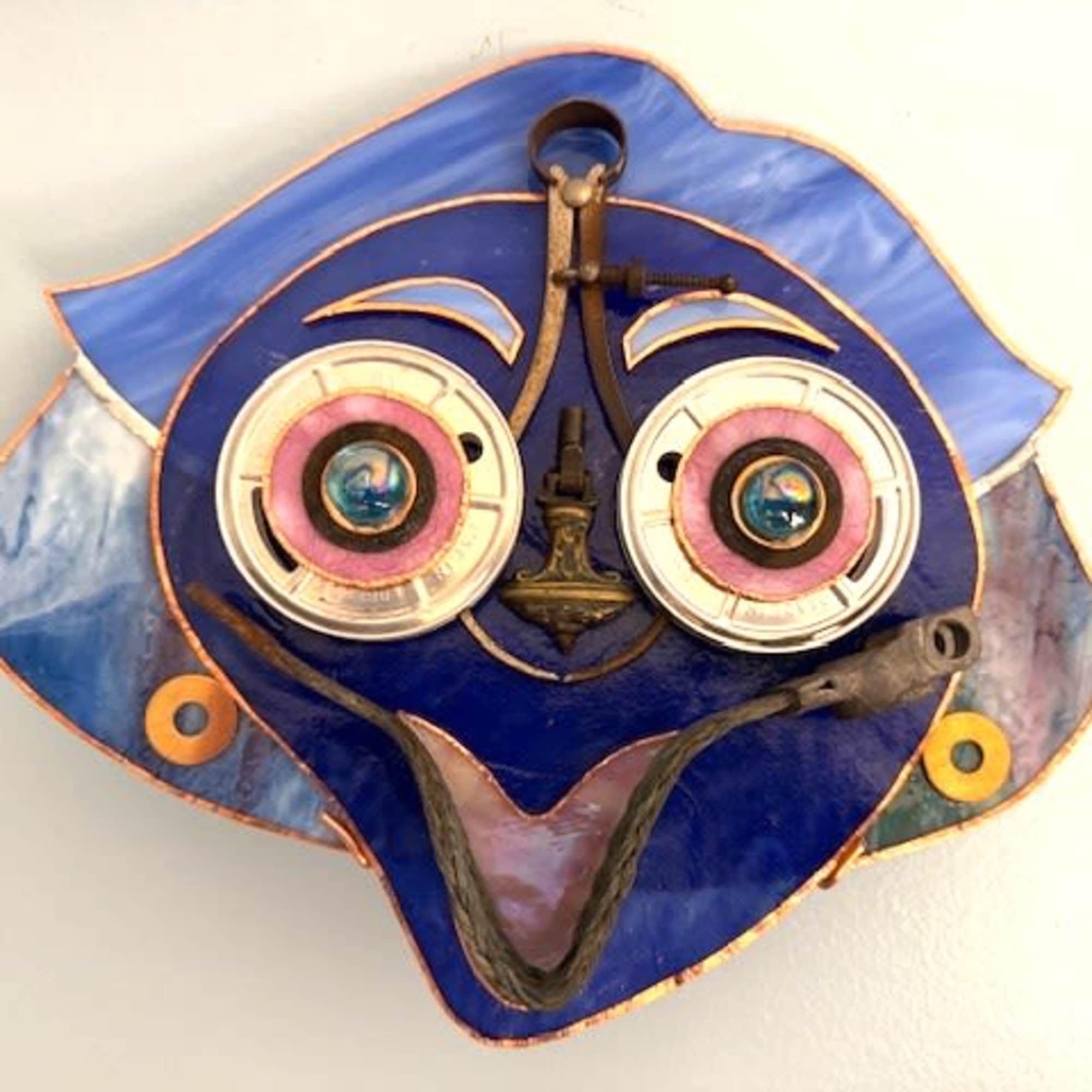 A bright, playful face in vivid blue tones greets the room-this mixed-media, photo 2 of 2