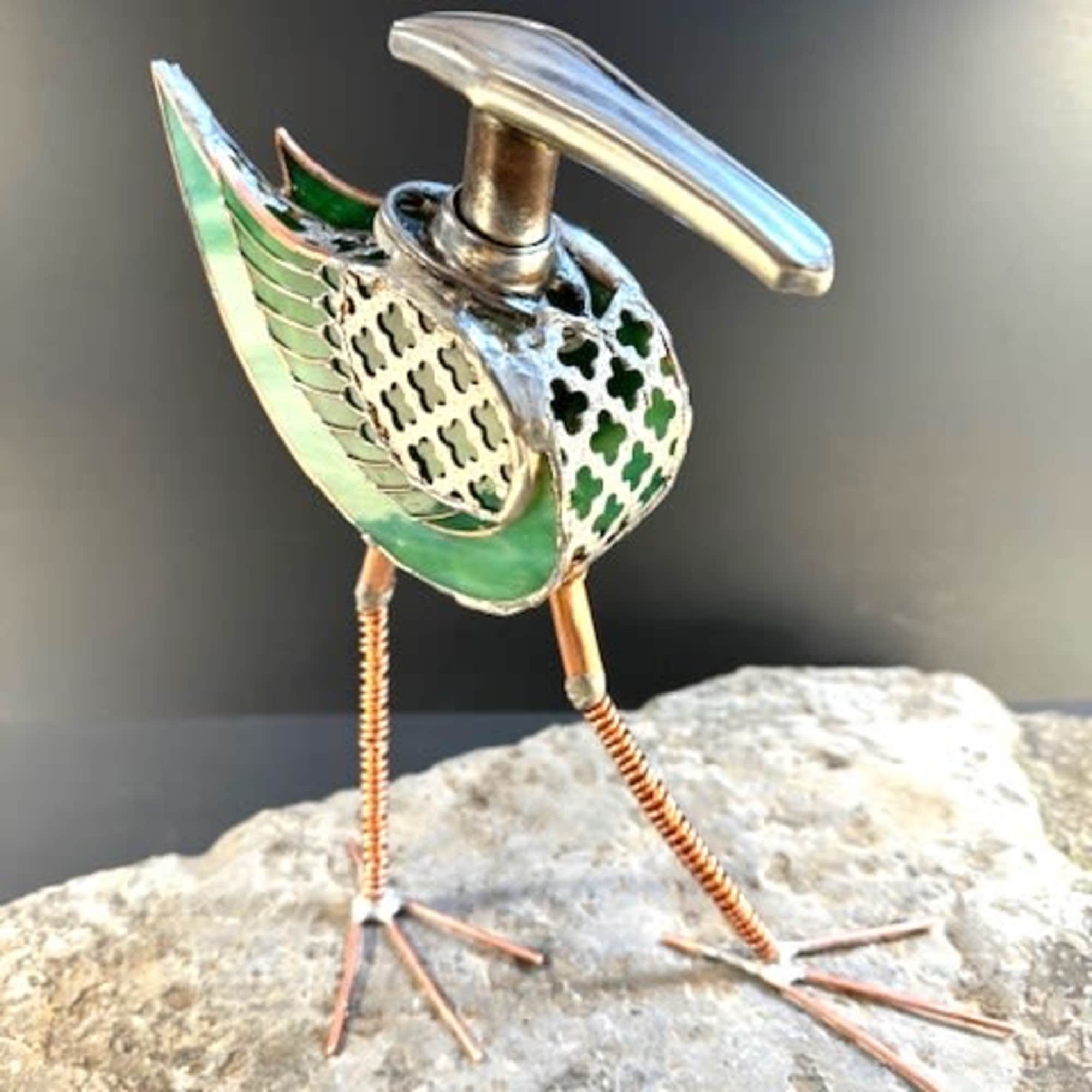 A whimsical mixed metal bird that reads like modern folk art. 