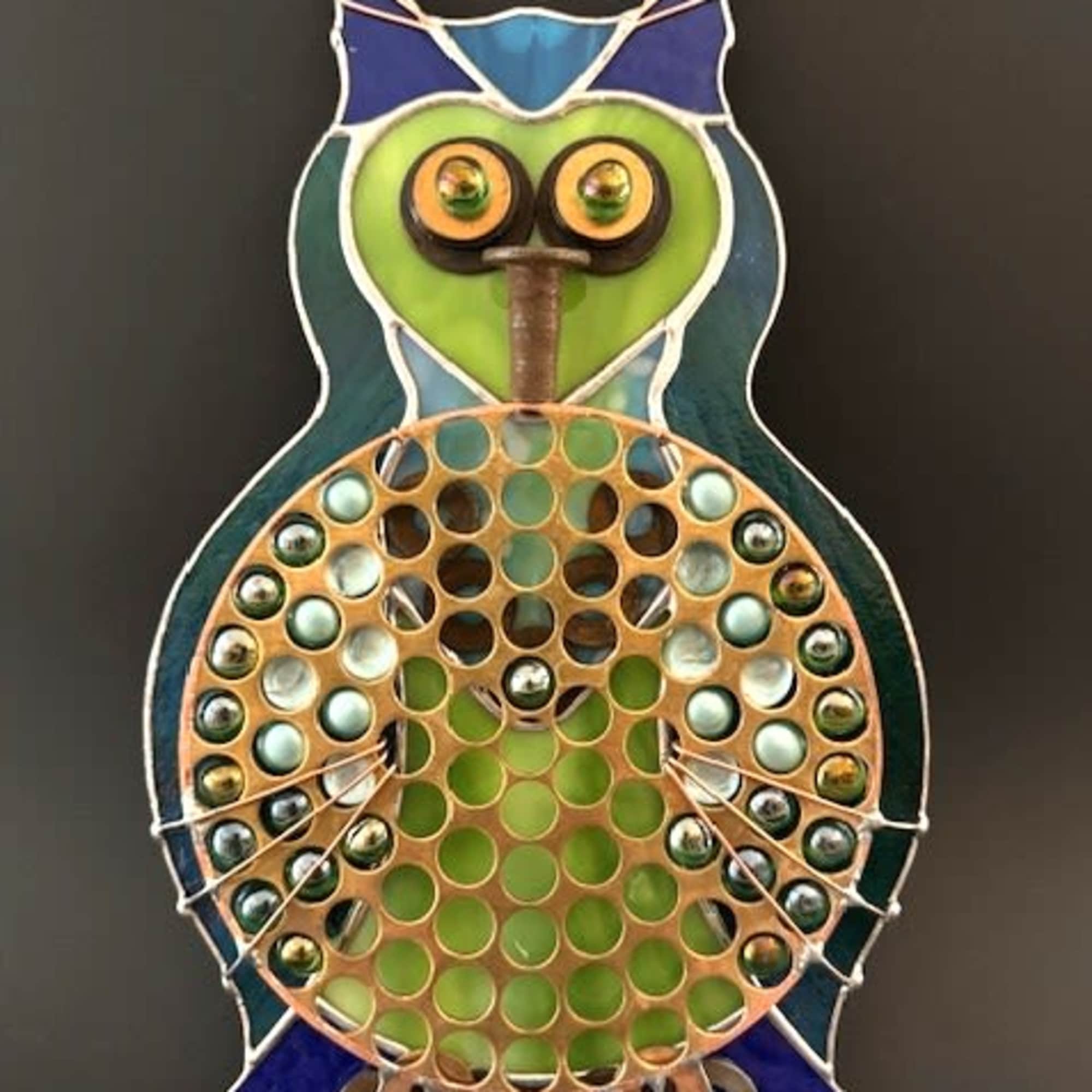  A playful metal and glass owl arrangement that doubles as a