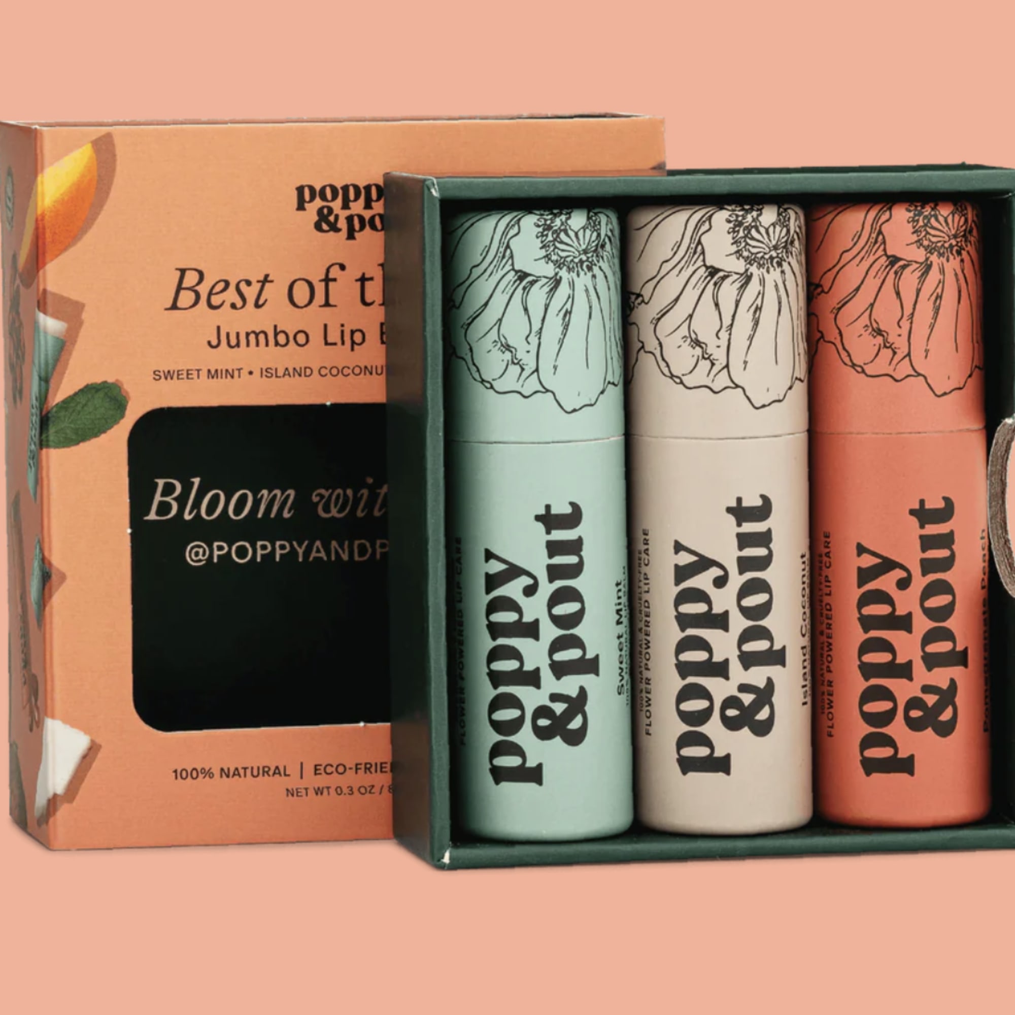 Three lip balm tubes in a gift box with an orange package behind them.