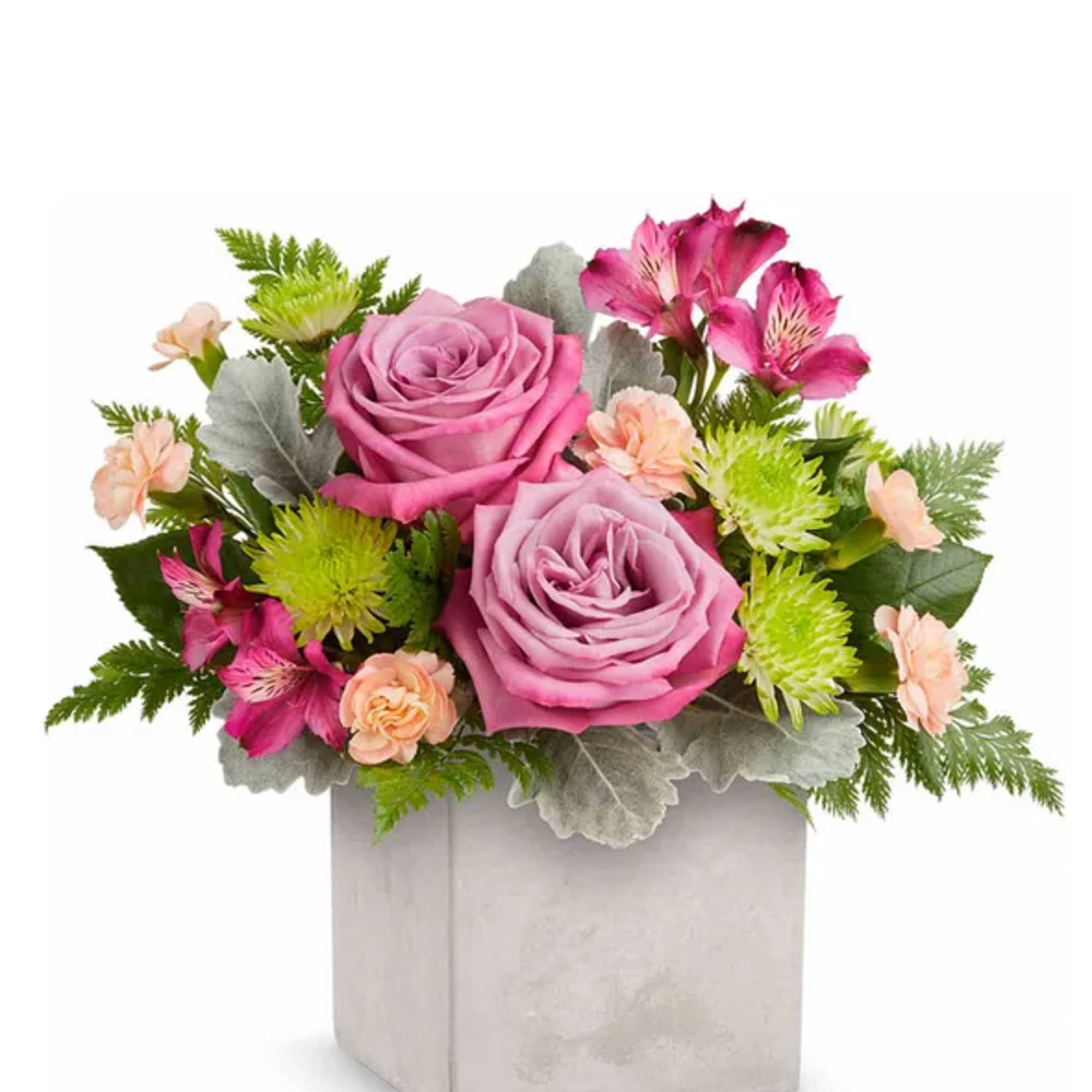 Pink roses and mixed blooms in a square gray vase