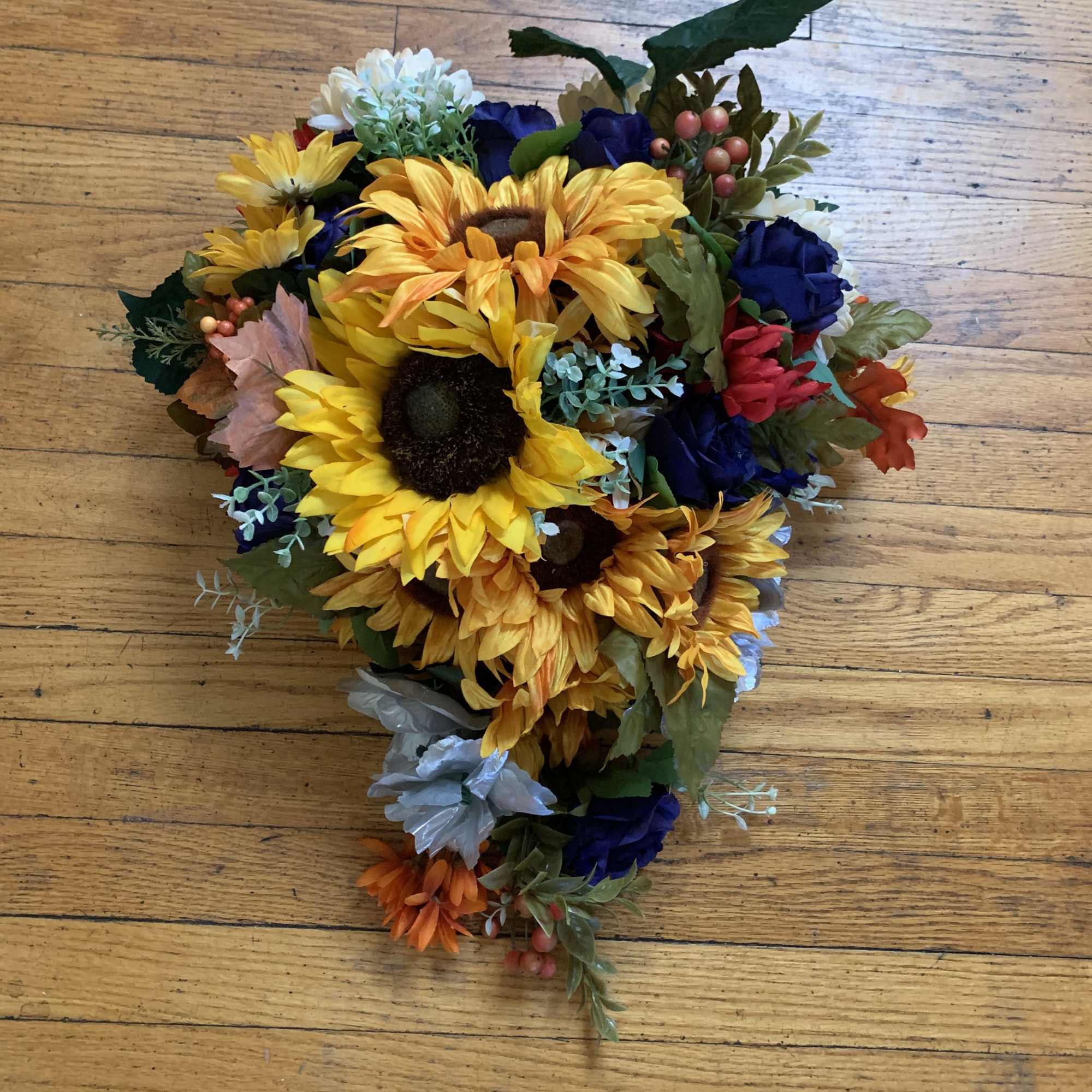 Bright, bold sunflowers take center stage in this sunflower bridal bouquet, a
