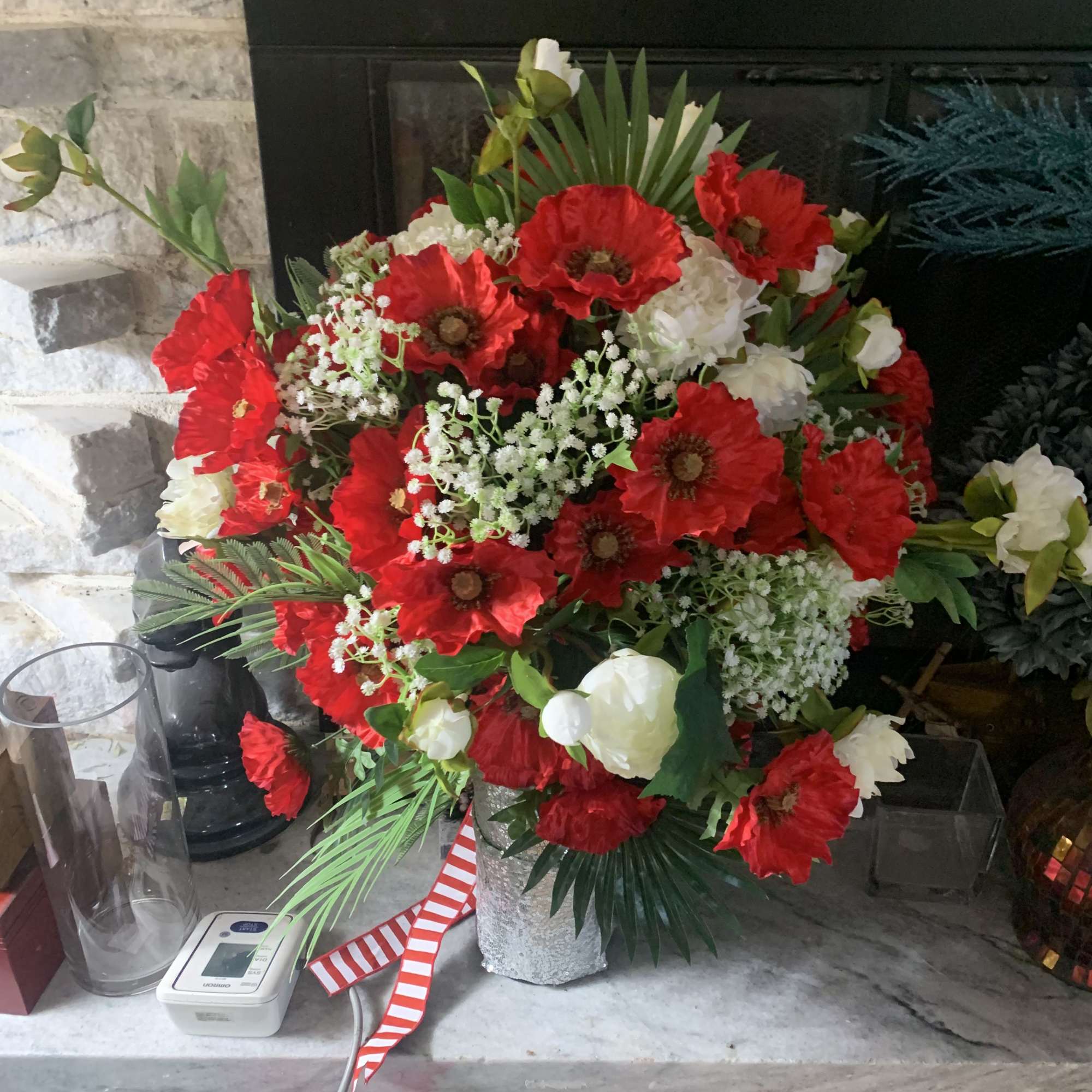 Bright, bold clusters of red poppy-like blooms explode against crisp white roses