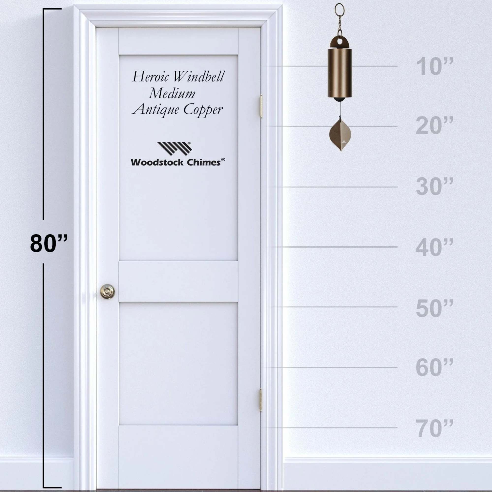 Antique copper wind chime hanging beside a door height chart