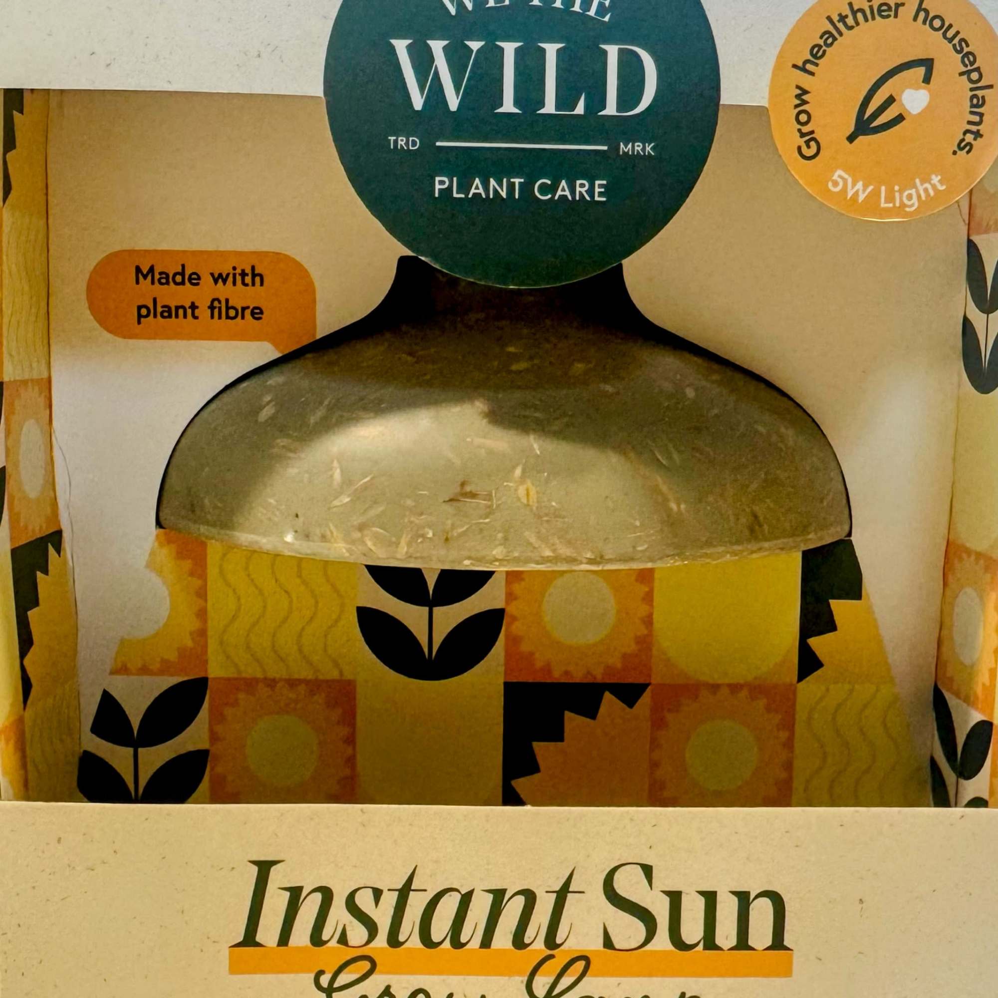 Boxed plant grow lamp with printed labels and a dome-shaped light