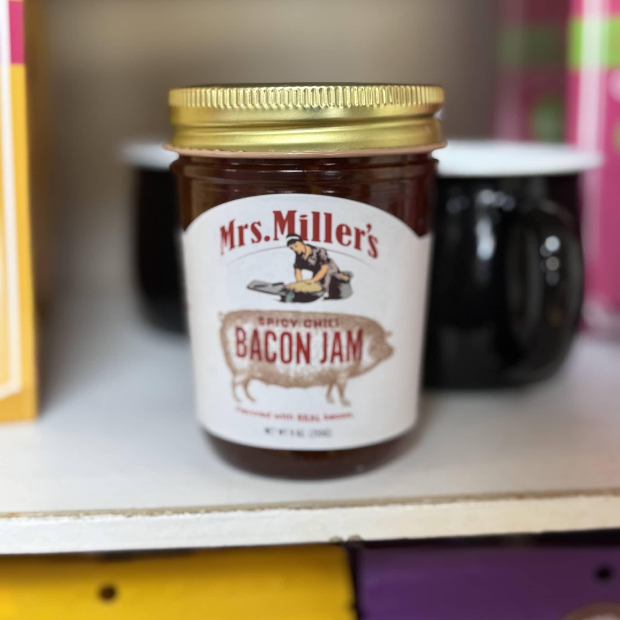 Jar of Mrs. Miller's bacon jam with a gold lid
