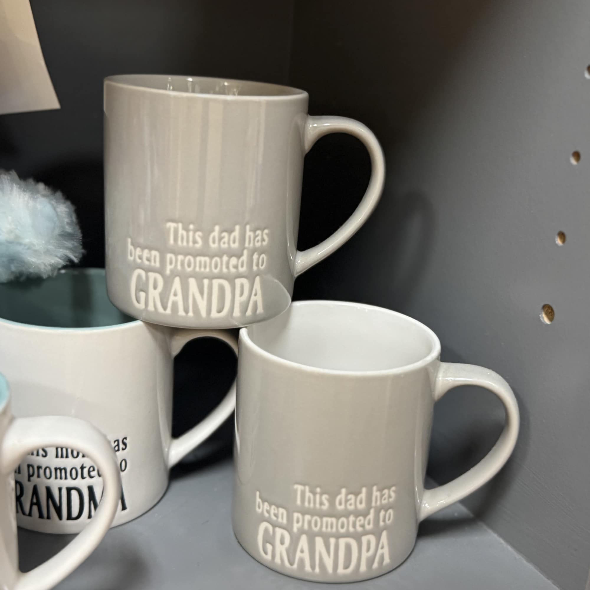 Gray ceramic mugs with the text "This dad has been promoted to GRANDPA"