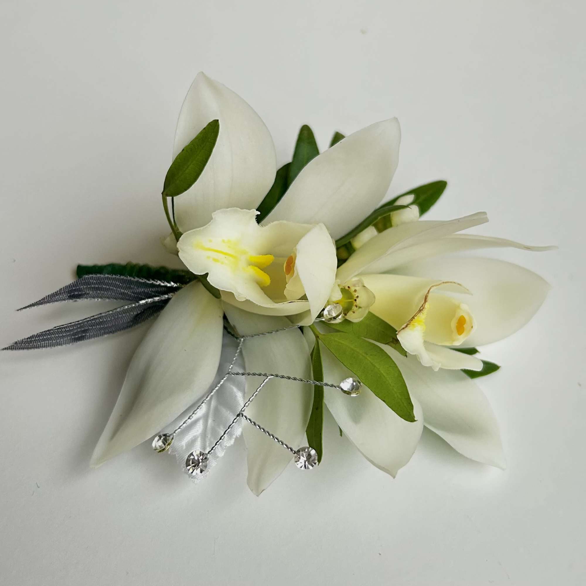 White orchid corsage with silver ribbon and crystal accents