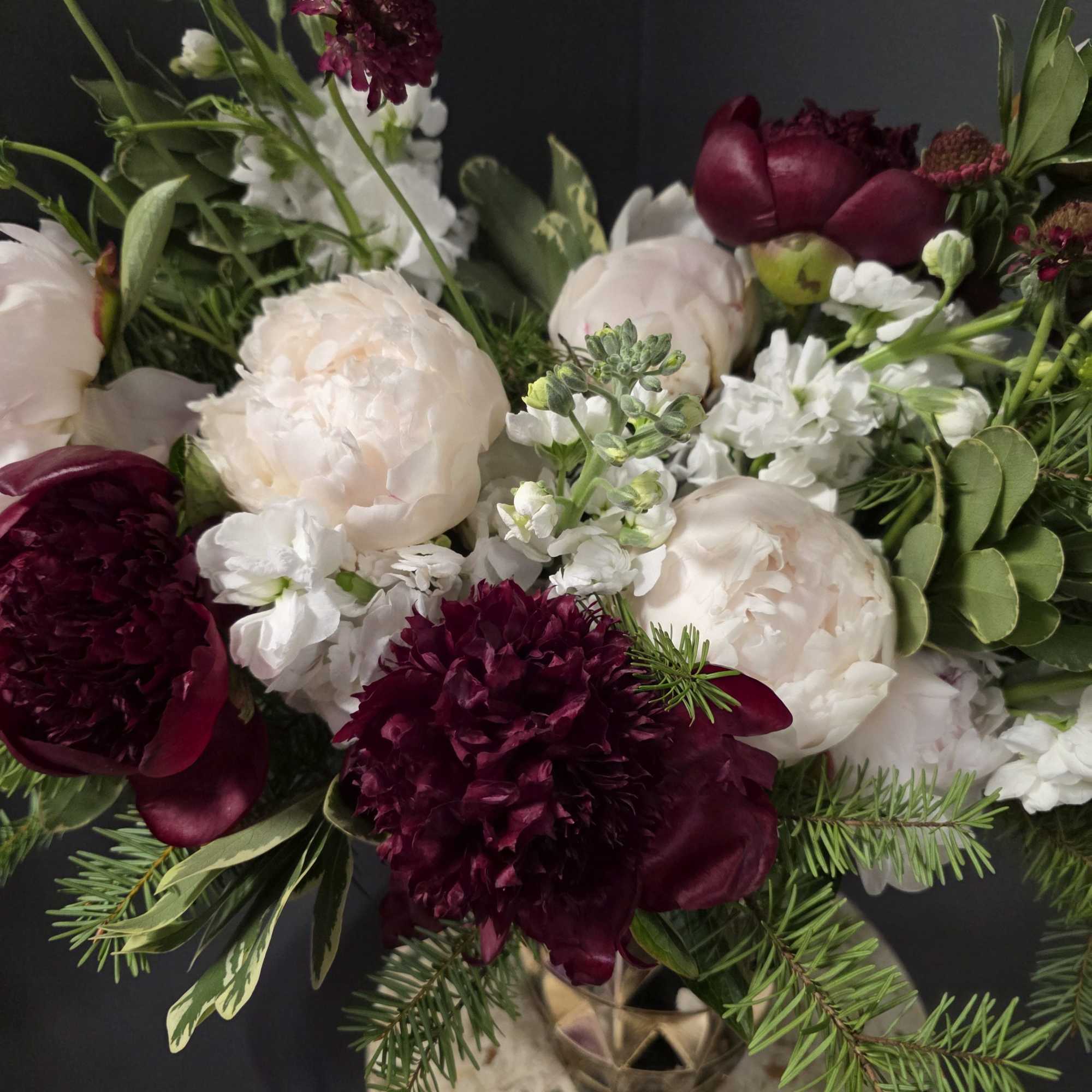 Bouquet of pale peonies and deep burgundy flowers with white accents