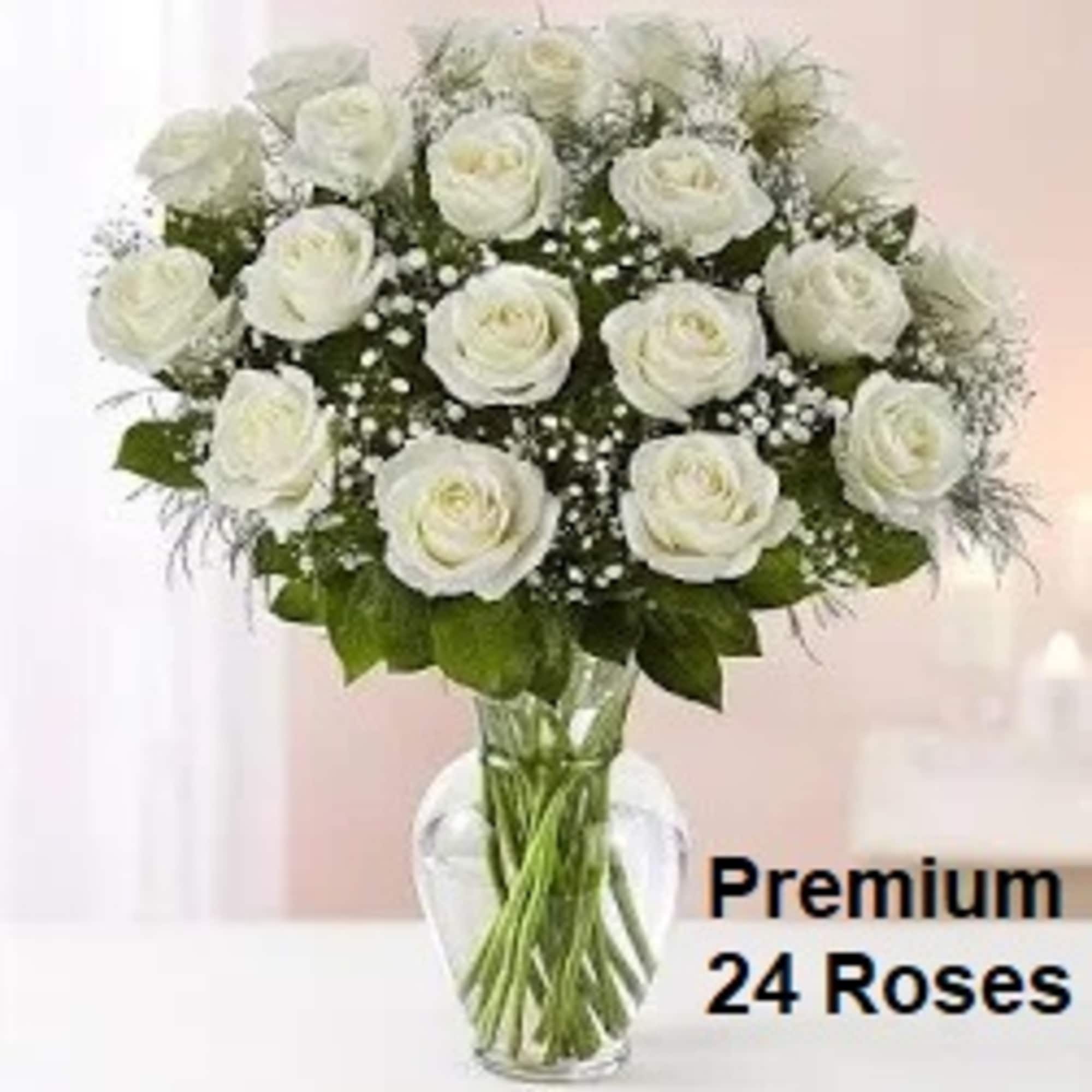 Tall arrangement of 24 white roses with baby's breath in a clear glass vase