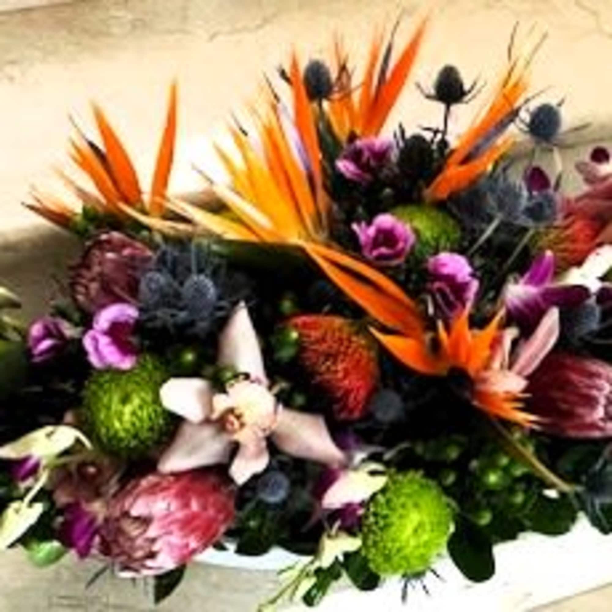 Tropical bouquet with orange bird-of-paradise and purple blooms