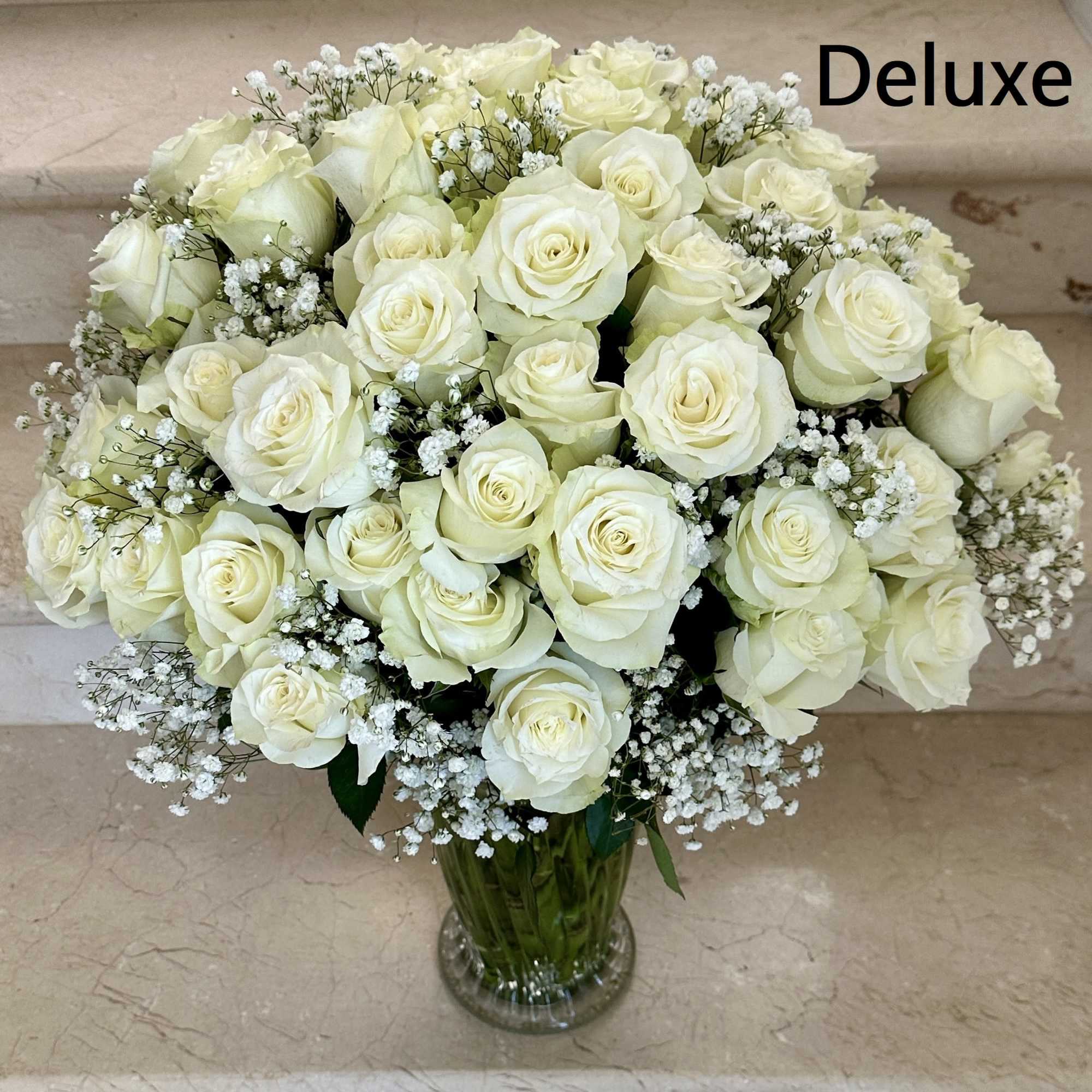 50 White Premium Roses arranged in a vase. Pave style.

