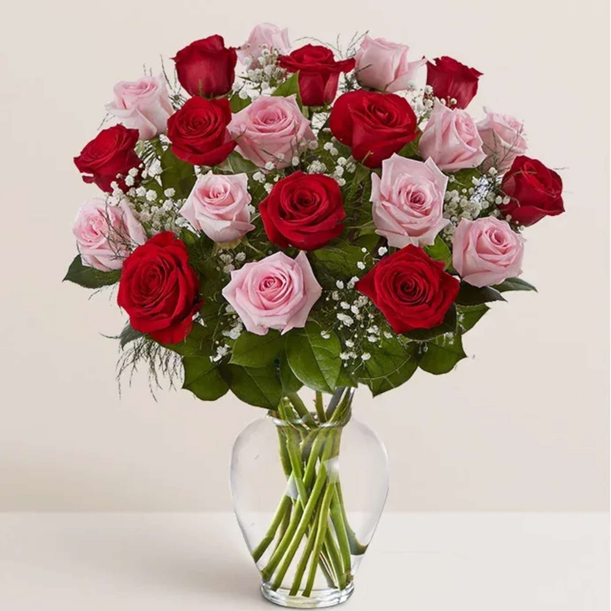 Red and pink roses in a clear glass vase