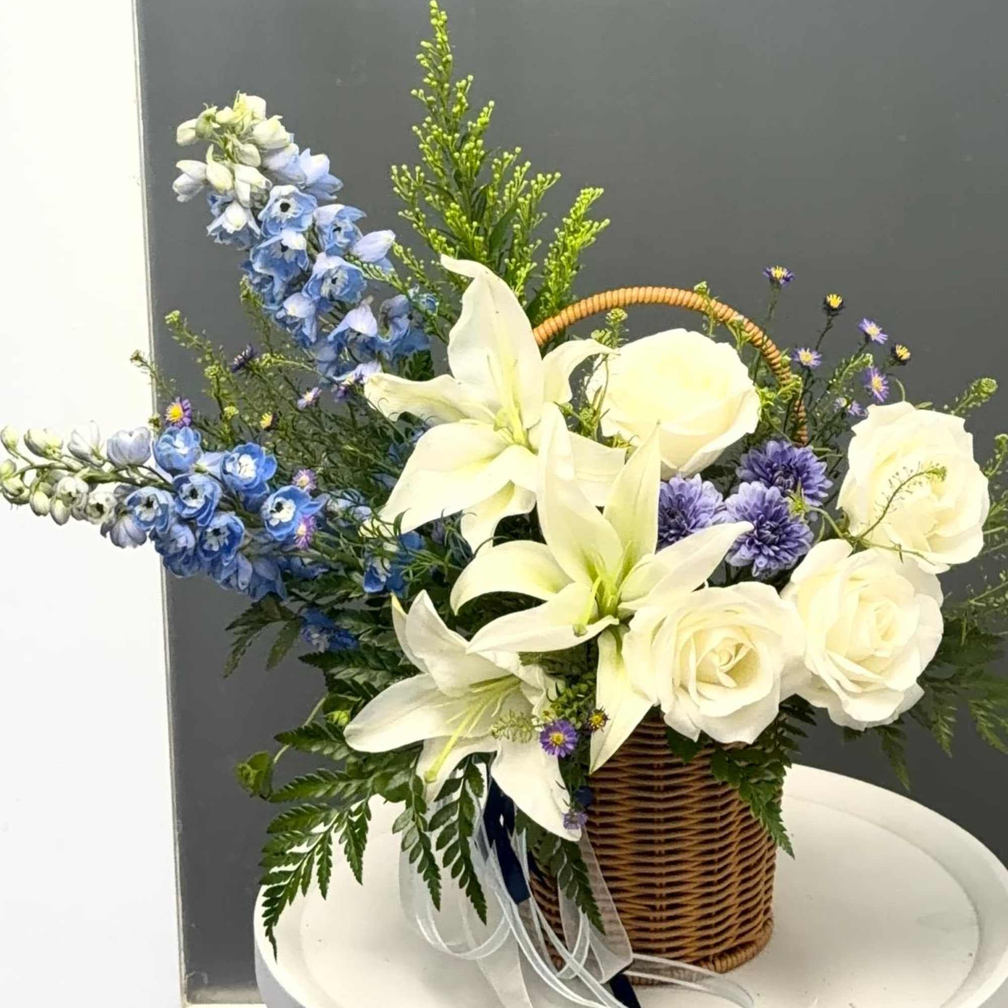 Cool, elegant and quietly dramatic-this basket arrangement brings together white lilies and, photo 2 of 3
