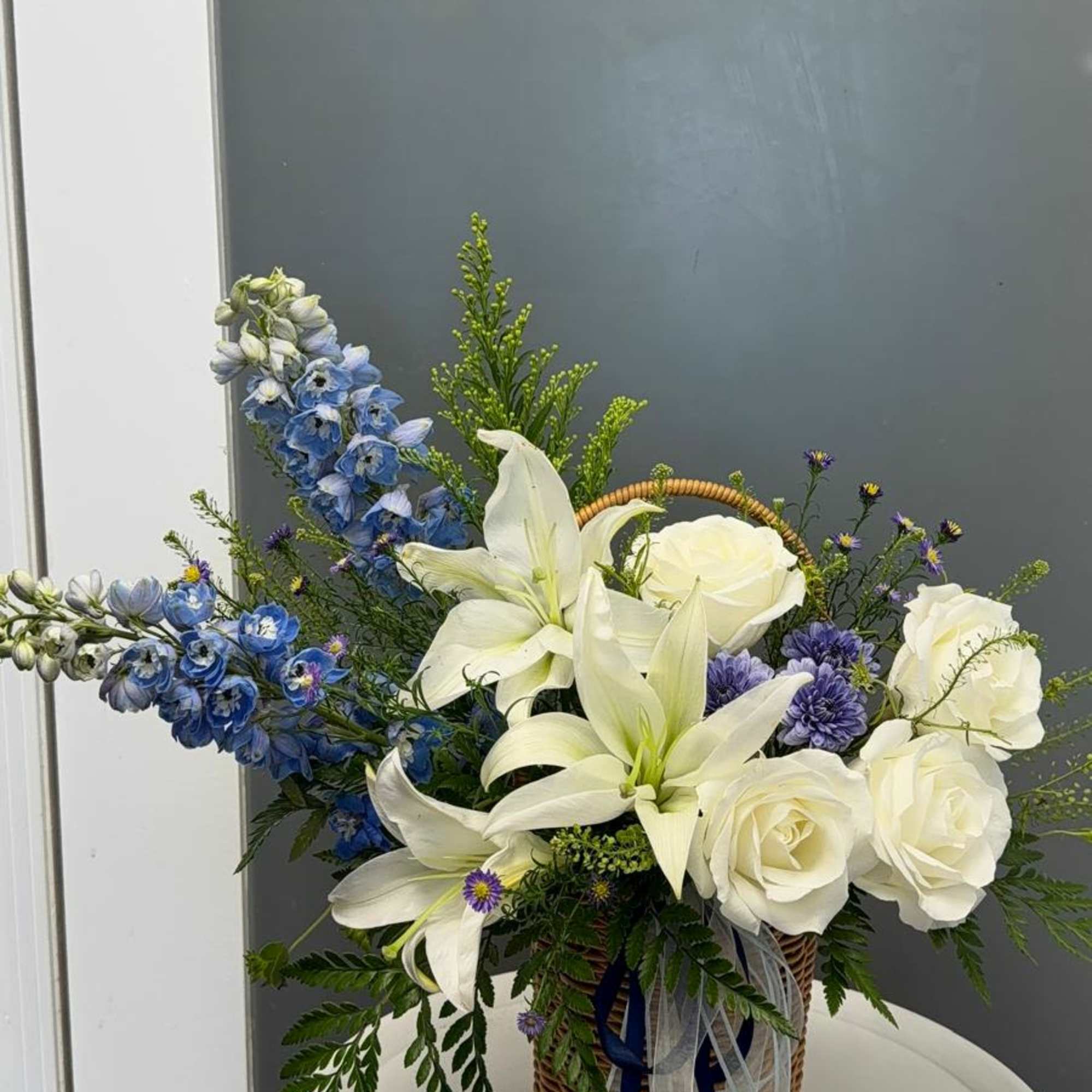 Cool, elegant and quietly dramatic-this basket arrangement brings together white lilies and, photo 3 of 3