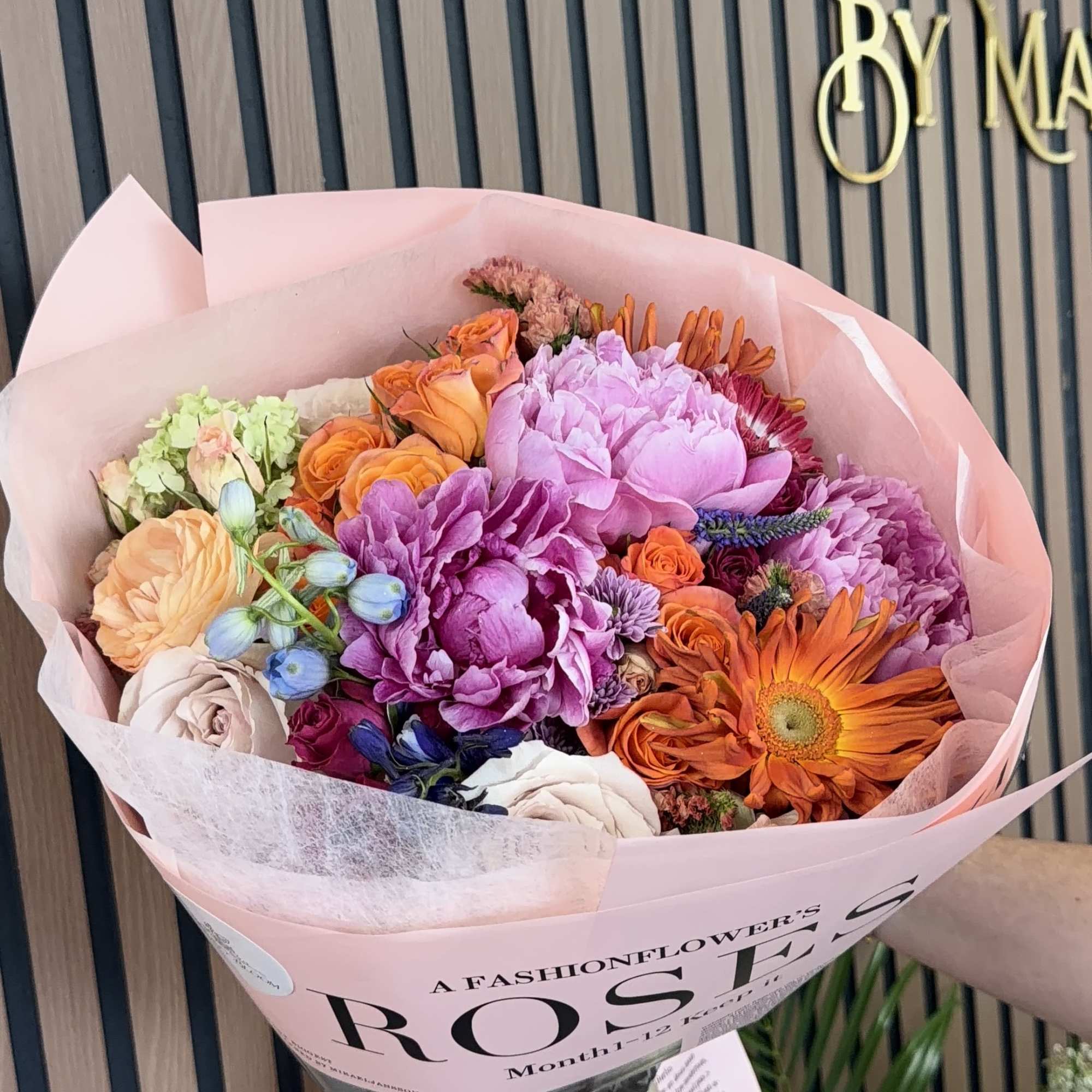 A lively, layered bouquet bursting with springtime joy-this hand-tied flower arrangement is