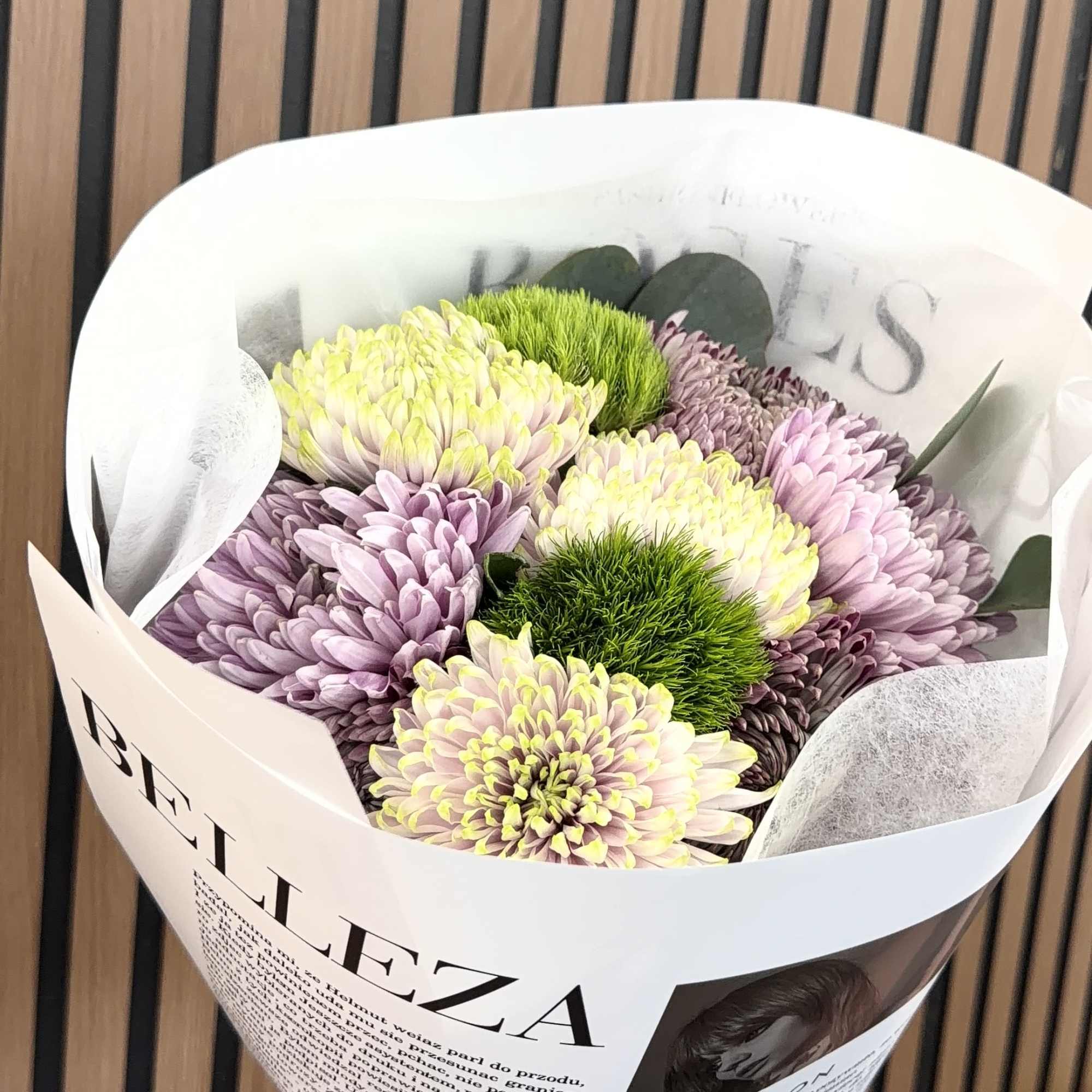 Soft lavender and creamy yellow-white chrysanthemums form a gently rounded bouquet that