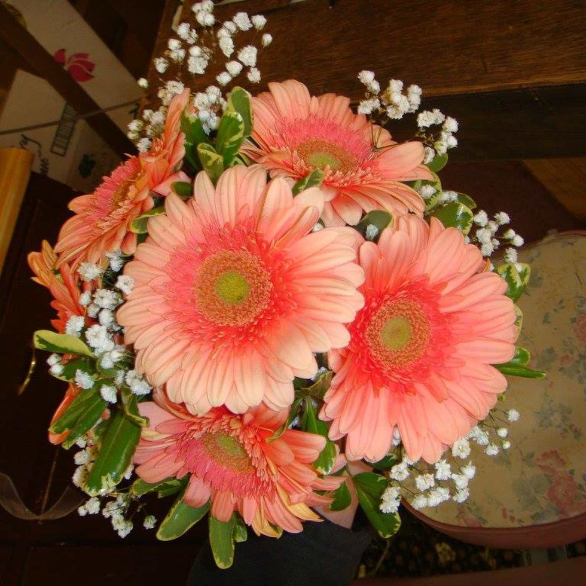 Bouquet of pink gerbera daisies with baby's breath and greenery