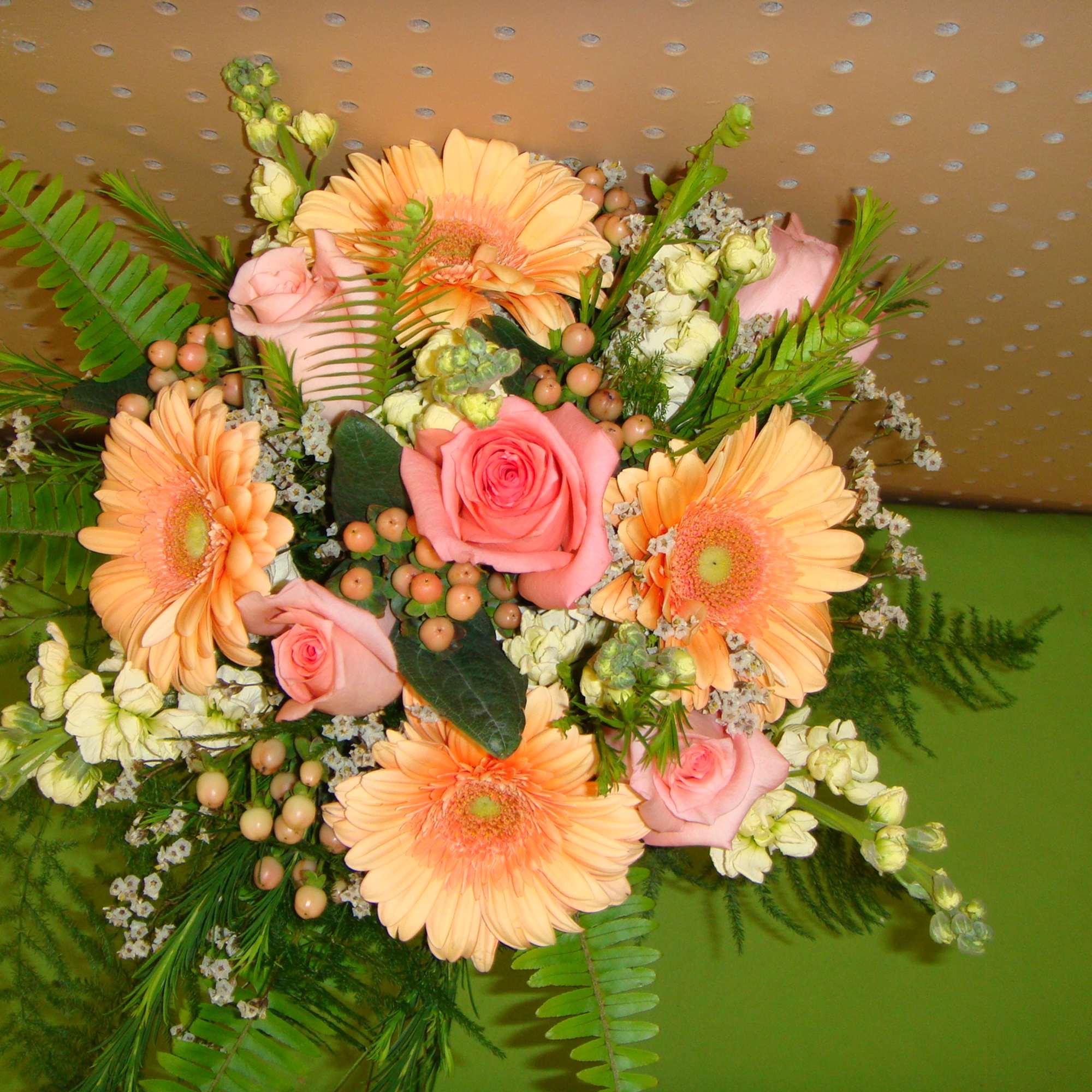Peach gerbera daisies and pink roses in a mixed bouquet