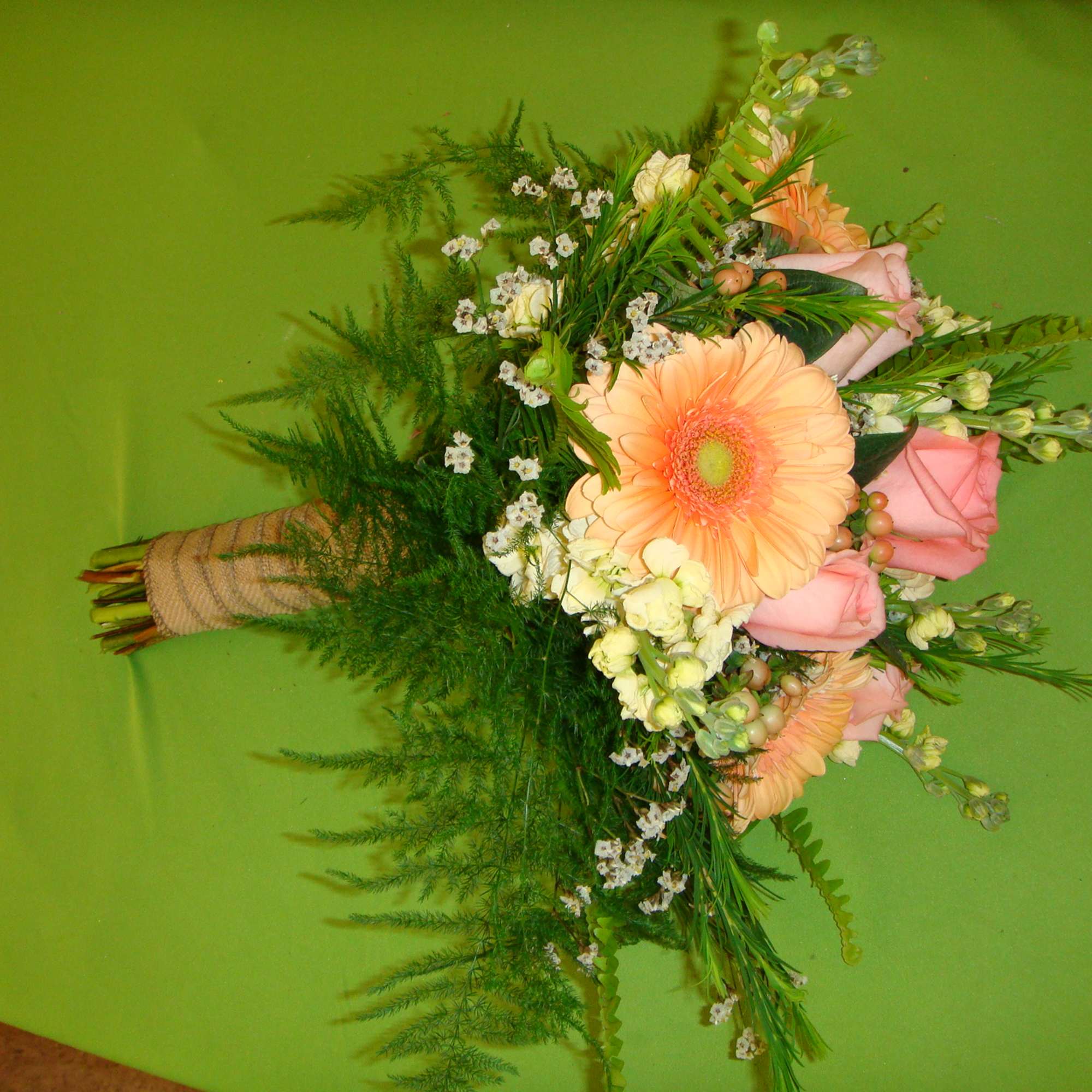 Hand-tied bouquet with peach gerbera daisies and pink roses