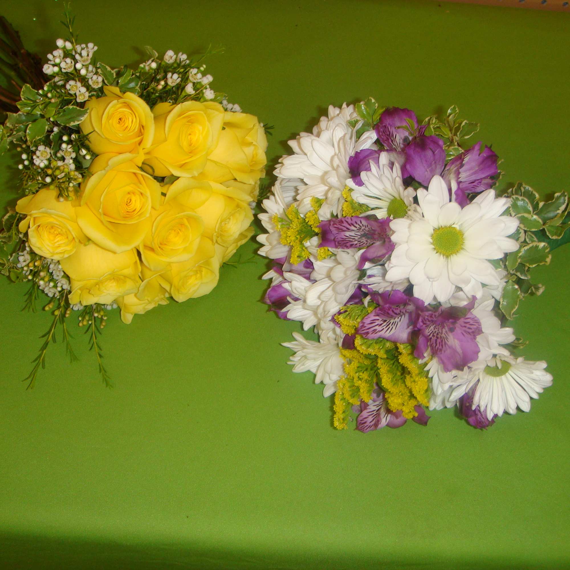 Two small bouquets, one with yellow roses and one with white and purple flowers.
