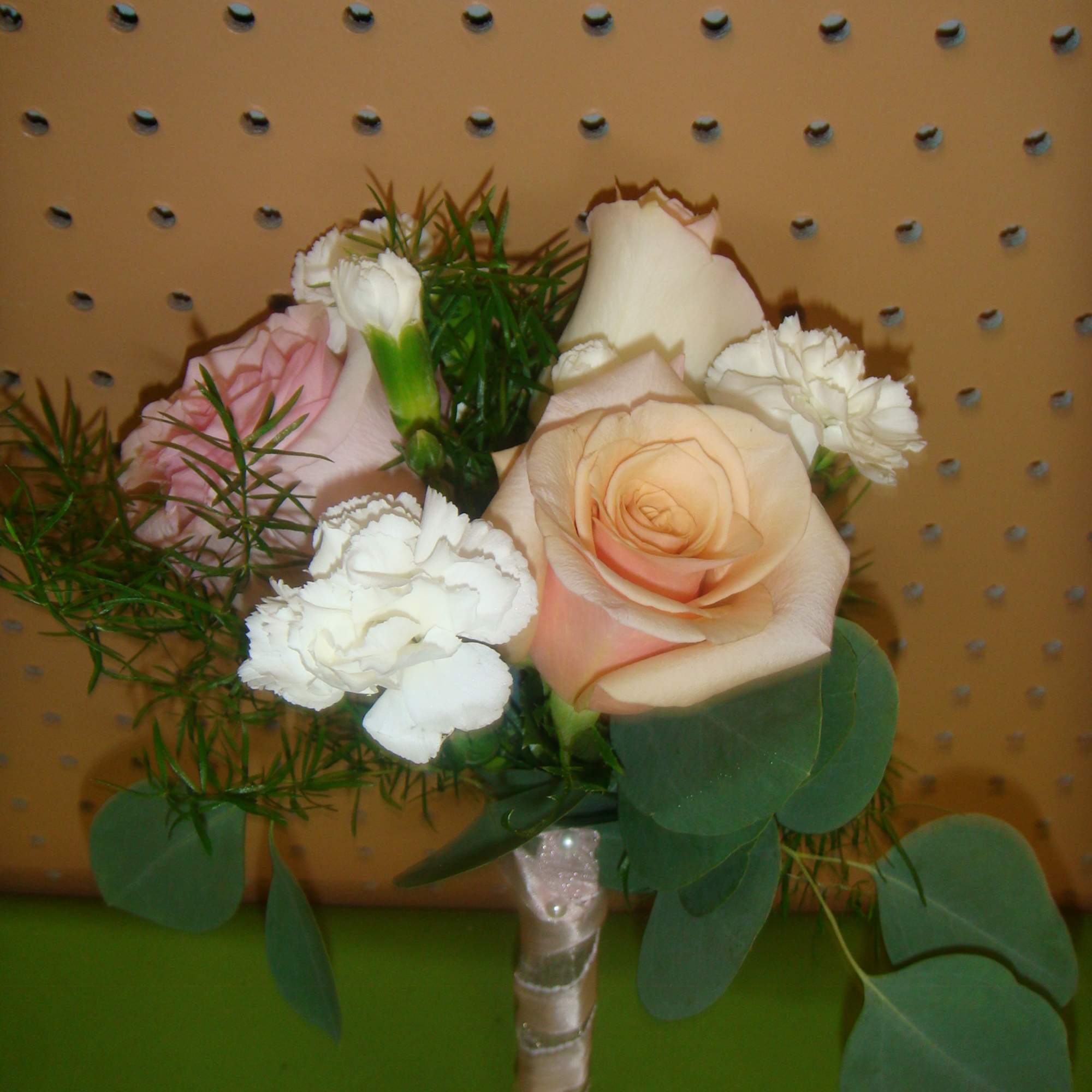 Small bouquet of peach and white roses with white carnations