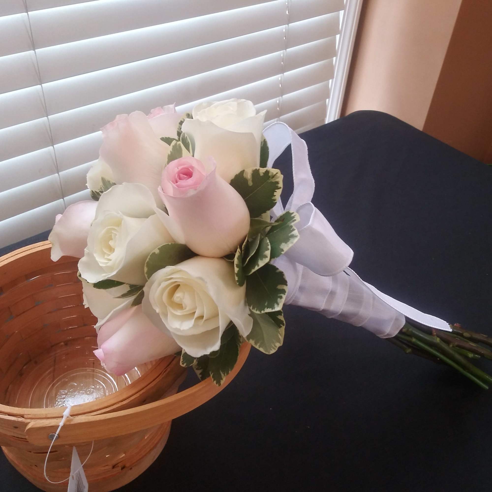 Bouquet of white and pale pink roses with ribbon wrap