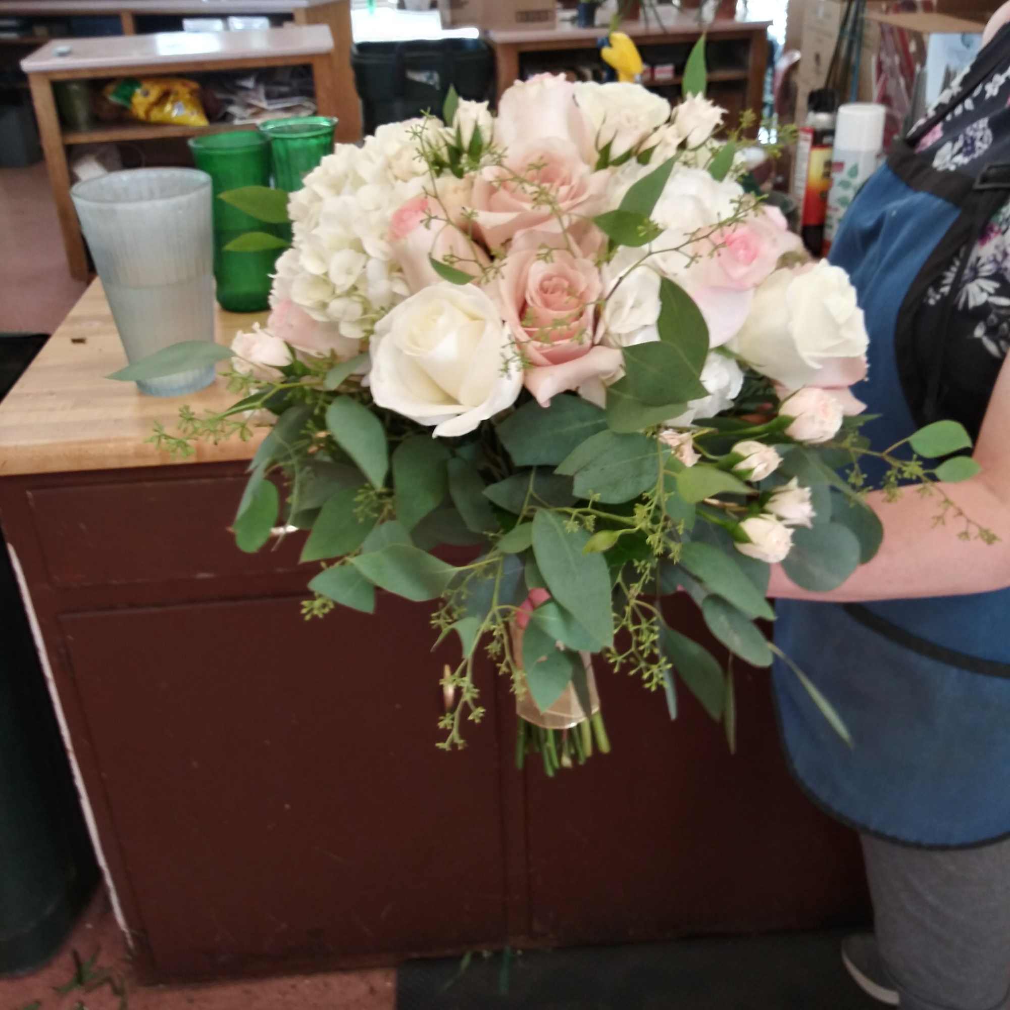 Bouquet of white and blush roses with greenery