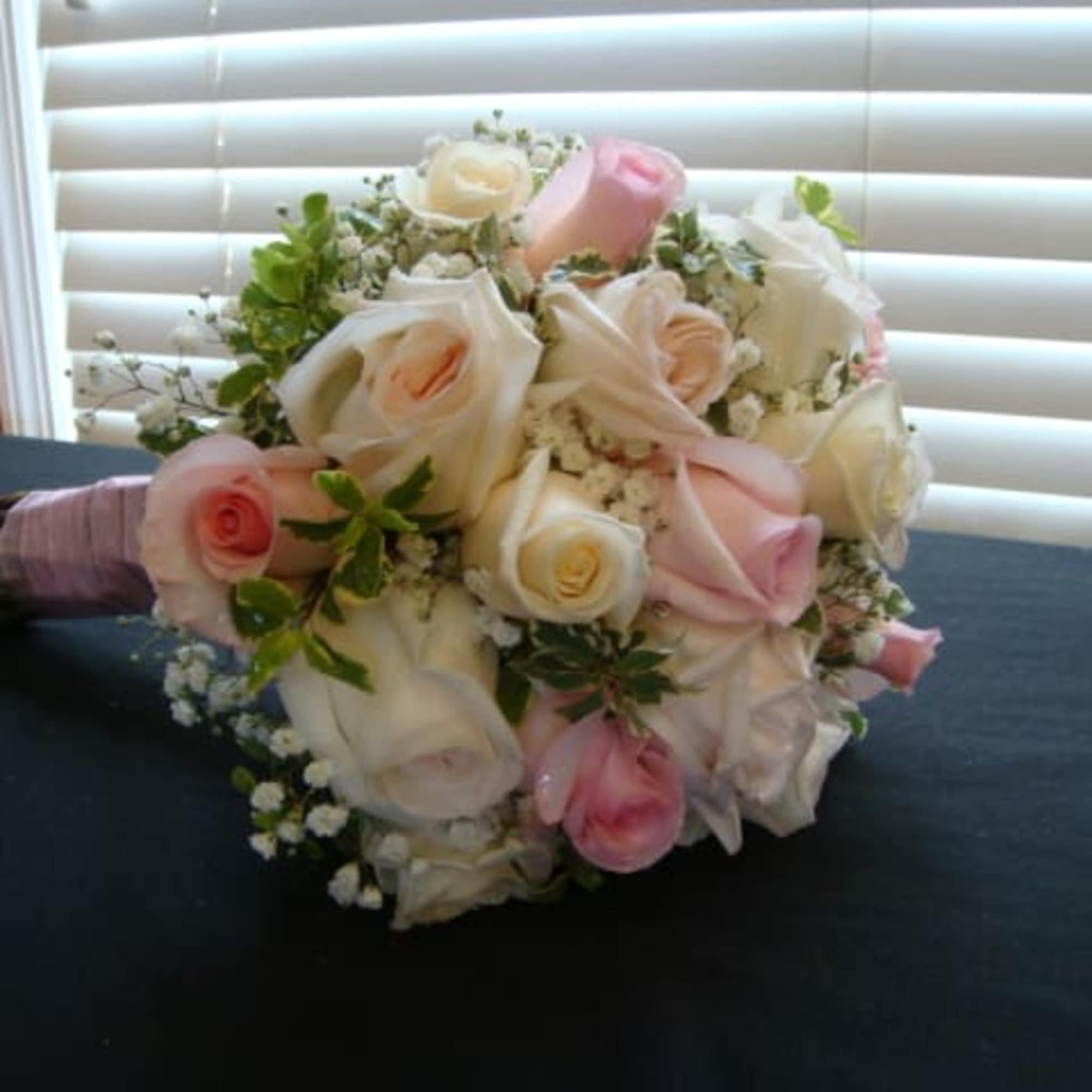 Bouquet of pale pink and white roses with baby's breath