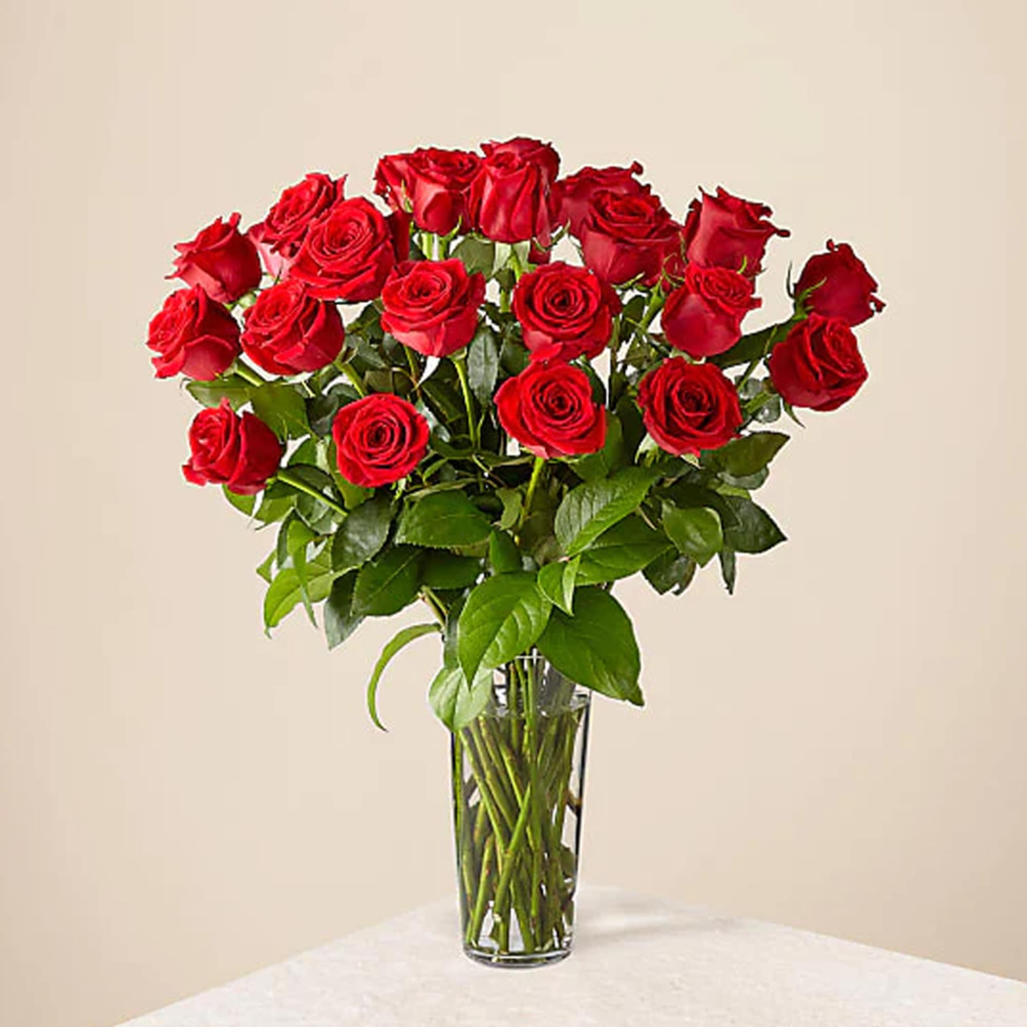 Red roses arranged in a clear glass vase