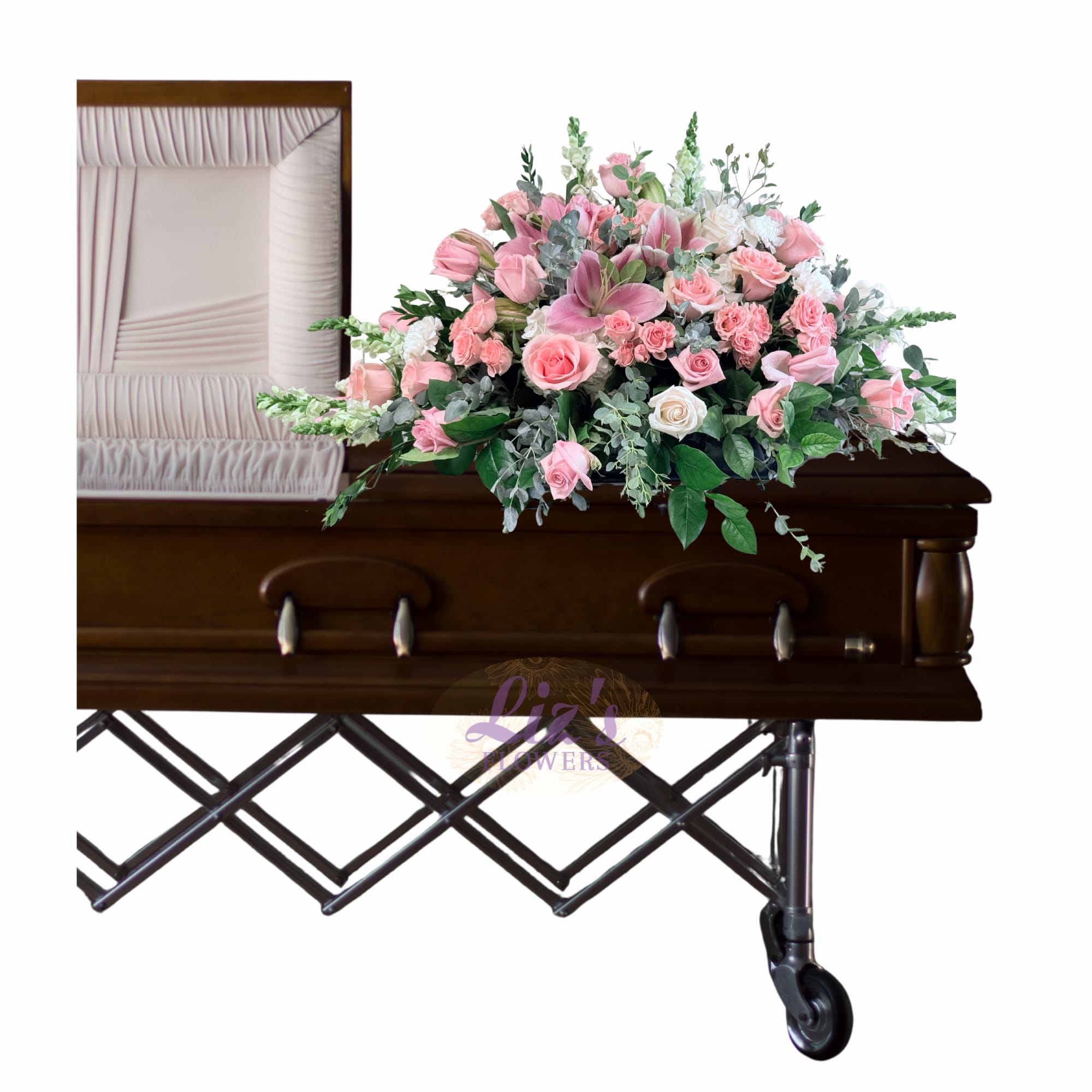 Pink floral casket spray with roses and lilies