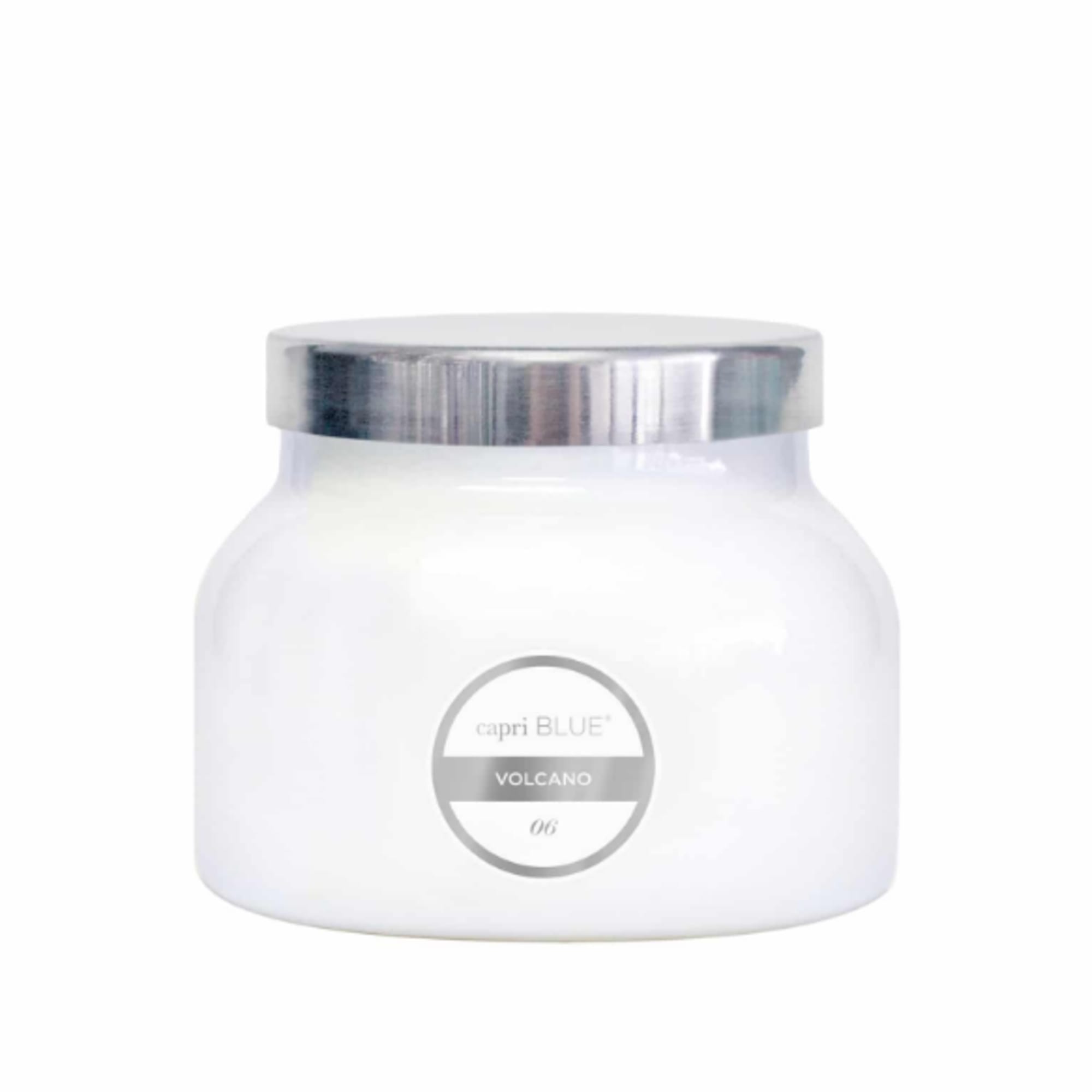 White candle jar with a silver lid and label