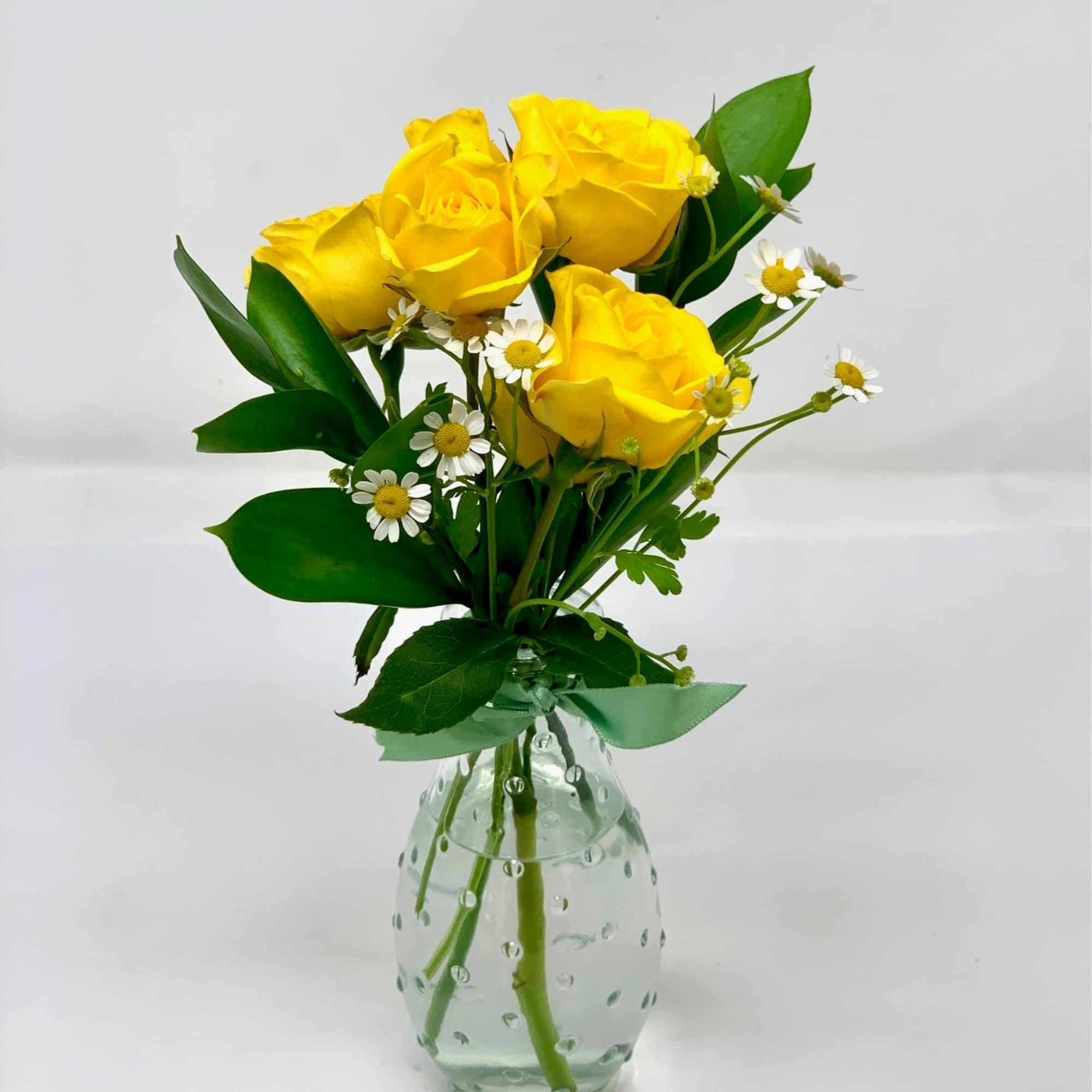 Each bud vase is arranged with one single seasonal flower, the thriller, photo 2 of 2