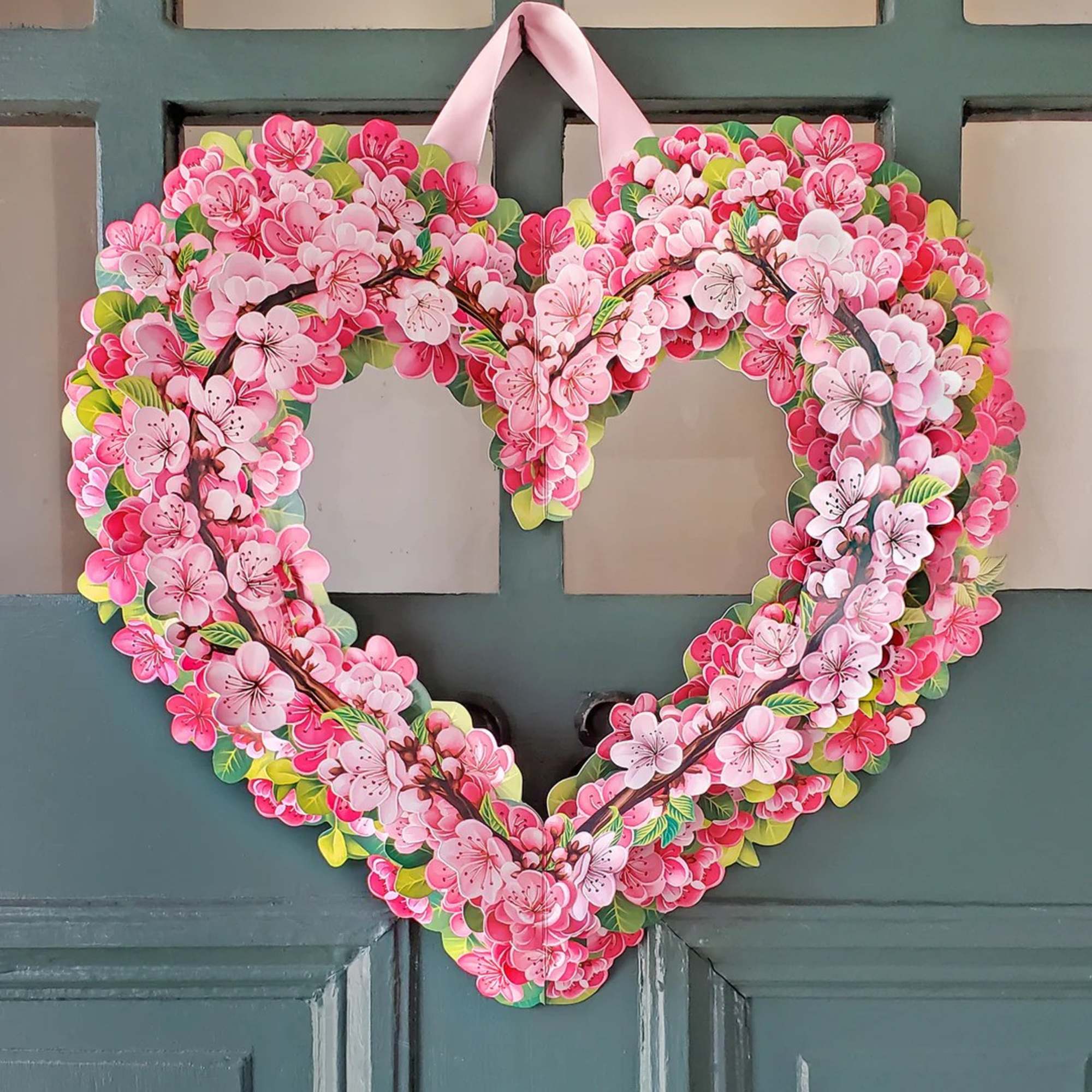 Stunning paper floral wreath pops open and brings color to any room.