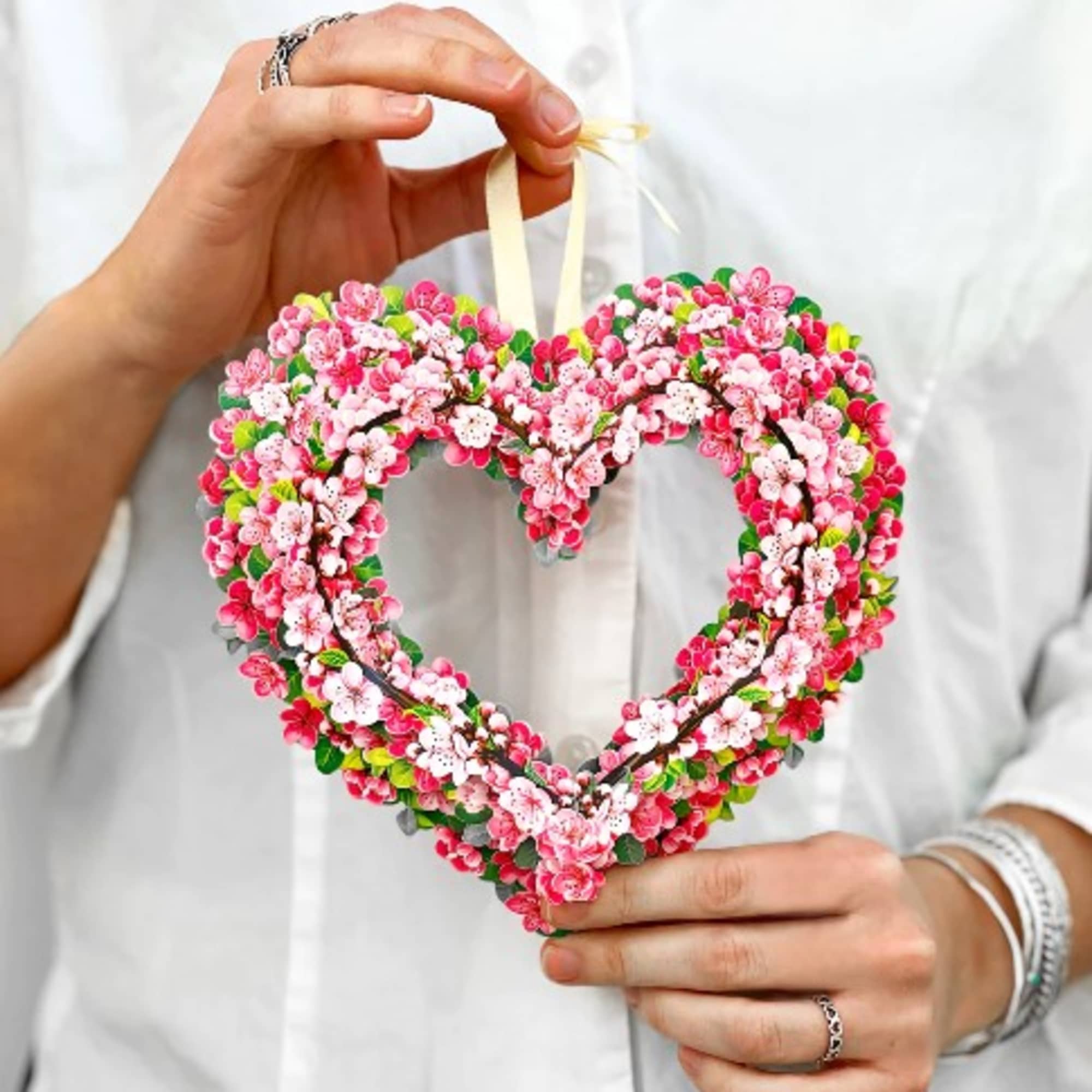 Heart-shaped floral ornament with pink and white blossoms