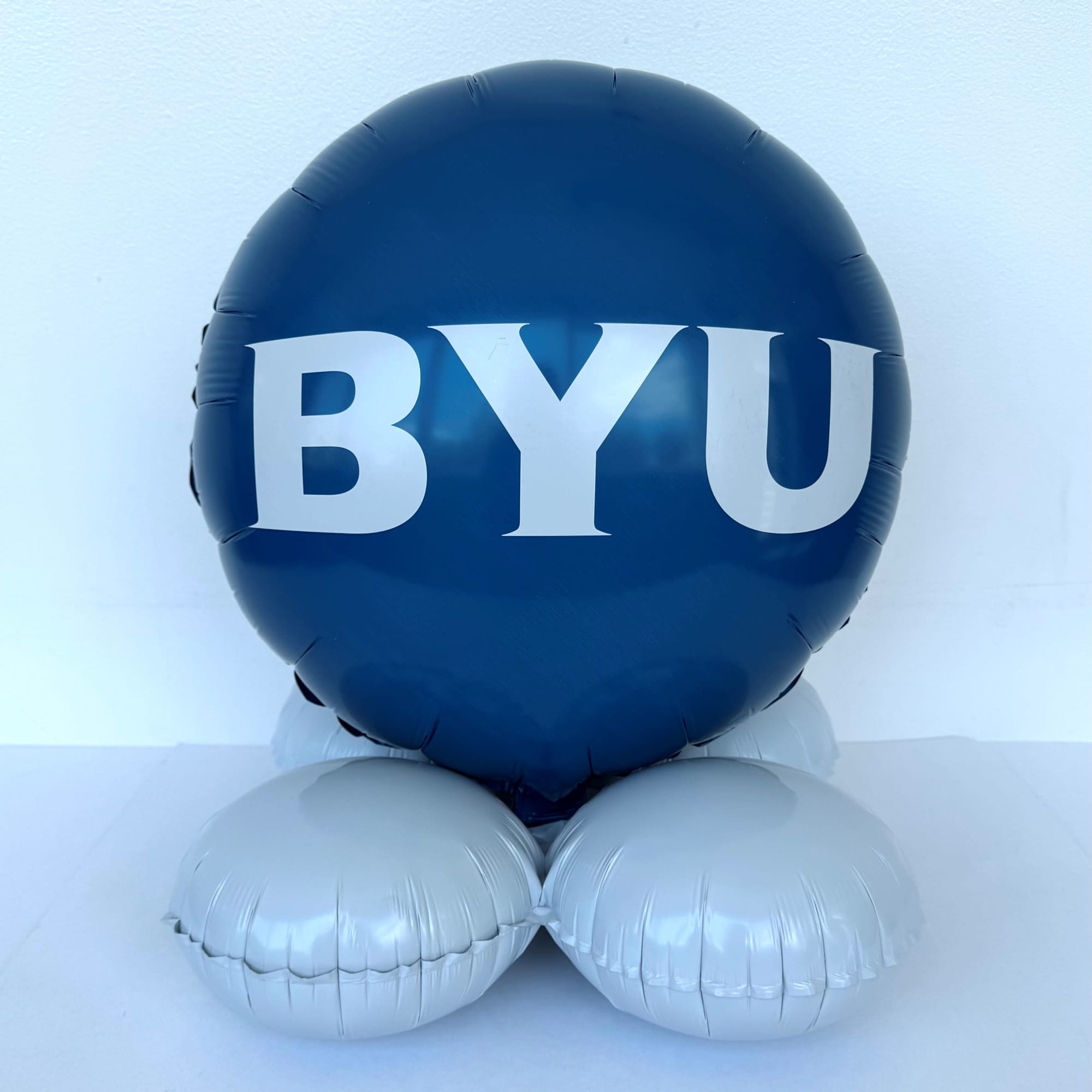 Blue balloon with white BYU lettering on silver balloon base