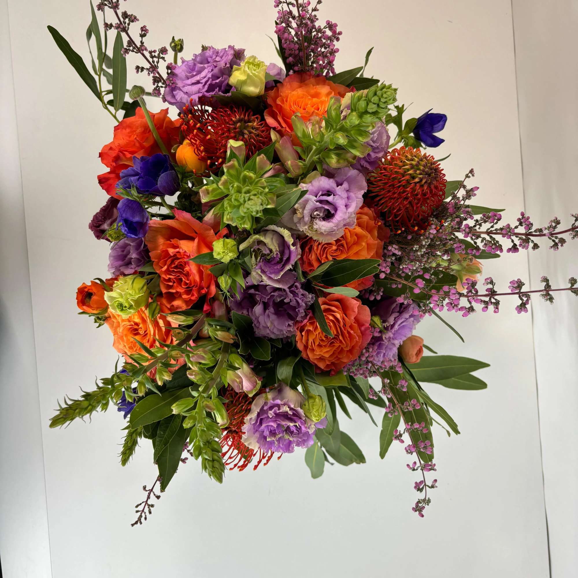Bright mixed bouquet with orange, purple, and pink flowers