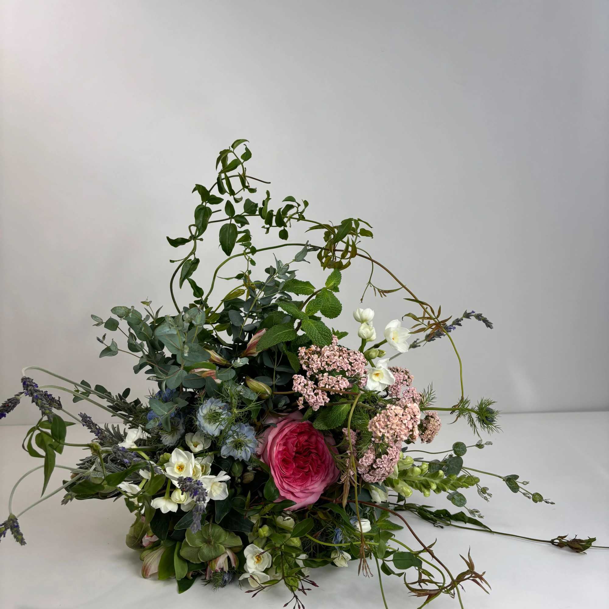 Loose bouquet with pink and white flowers and trailing greenery