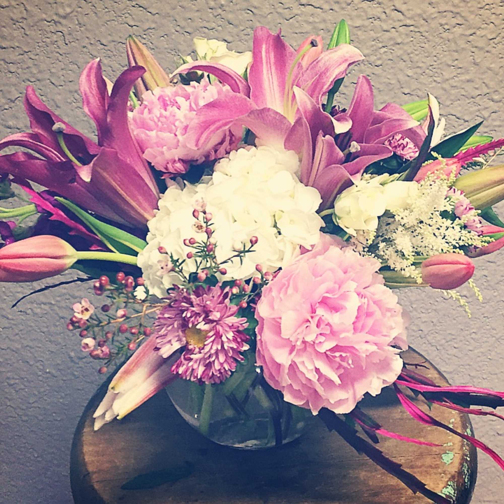 Pink and white floral arrangement in a glass vase