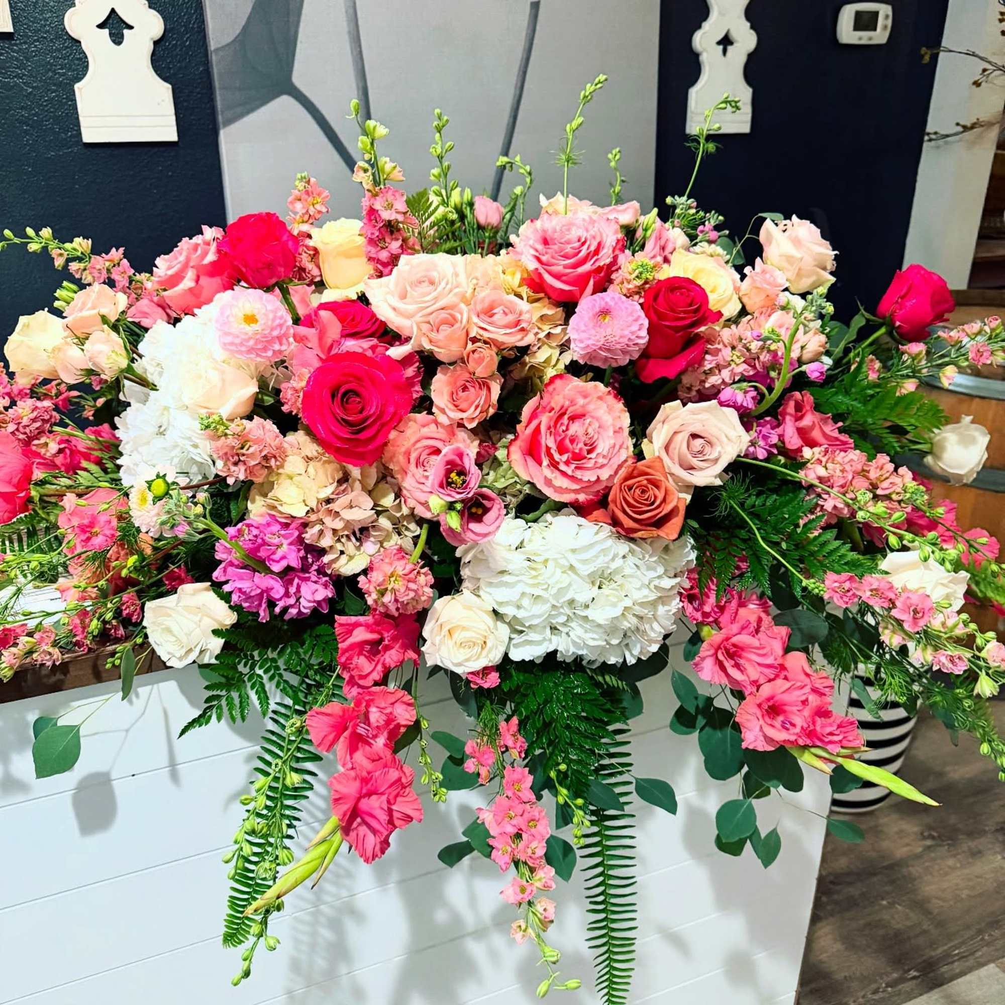 Large pink and white floral arrangement with roses and hydrangeas
