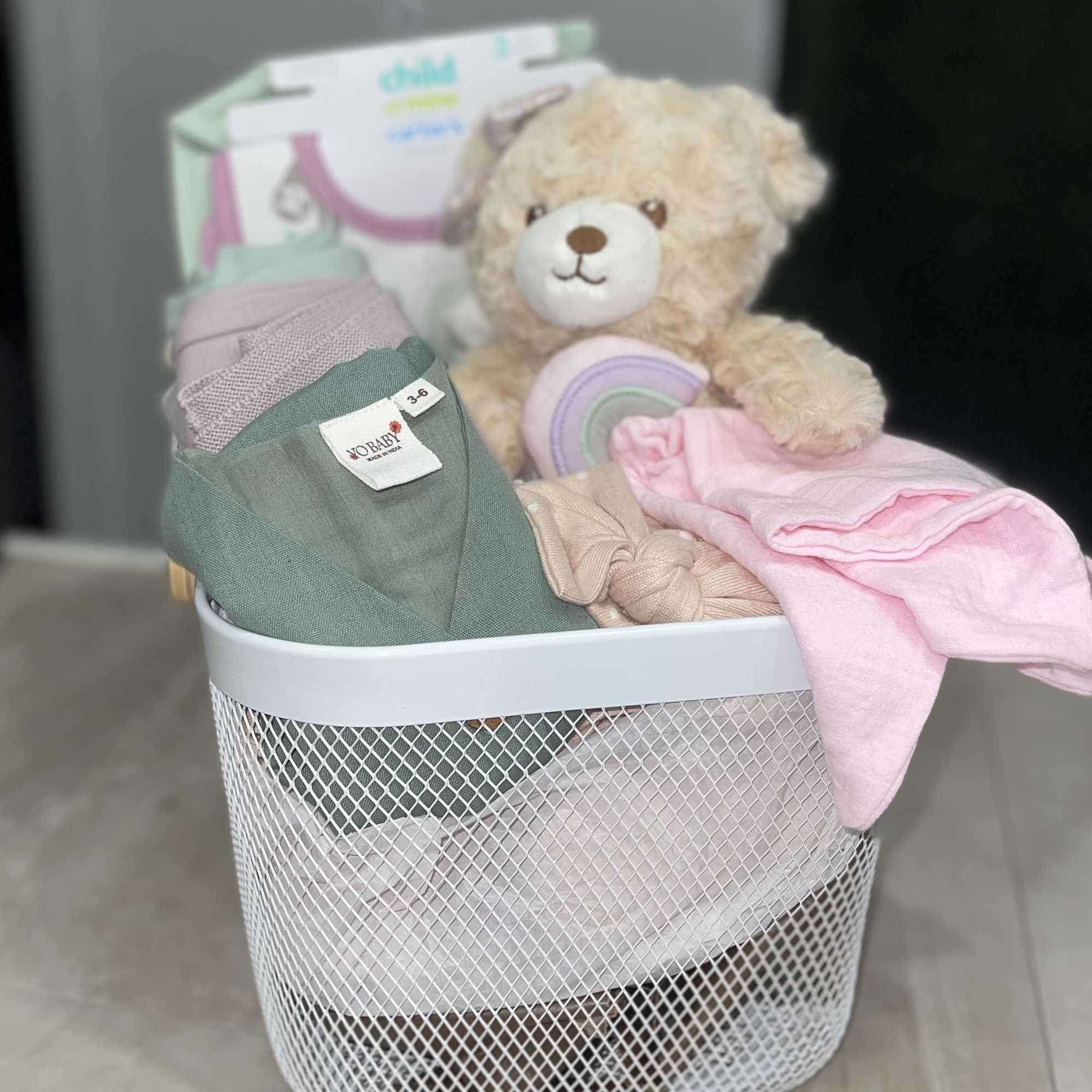 Soft pastels and cuddly textures make this Hello Baby Girl Basket the