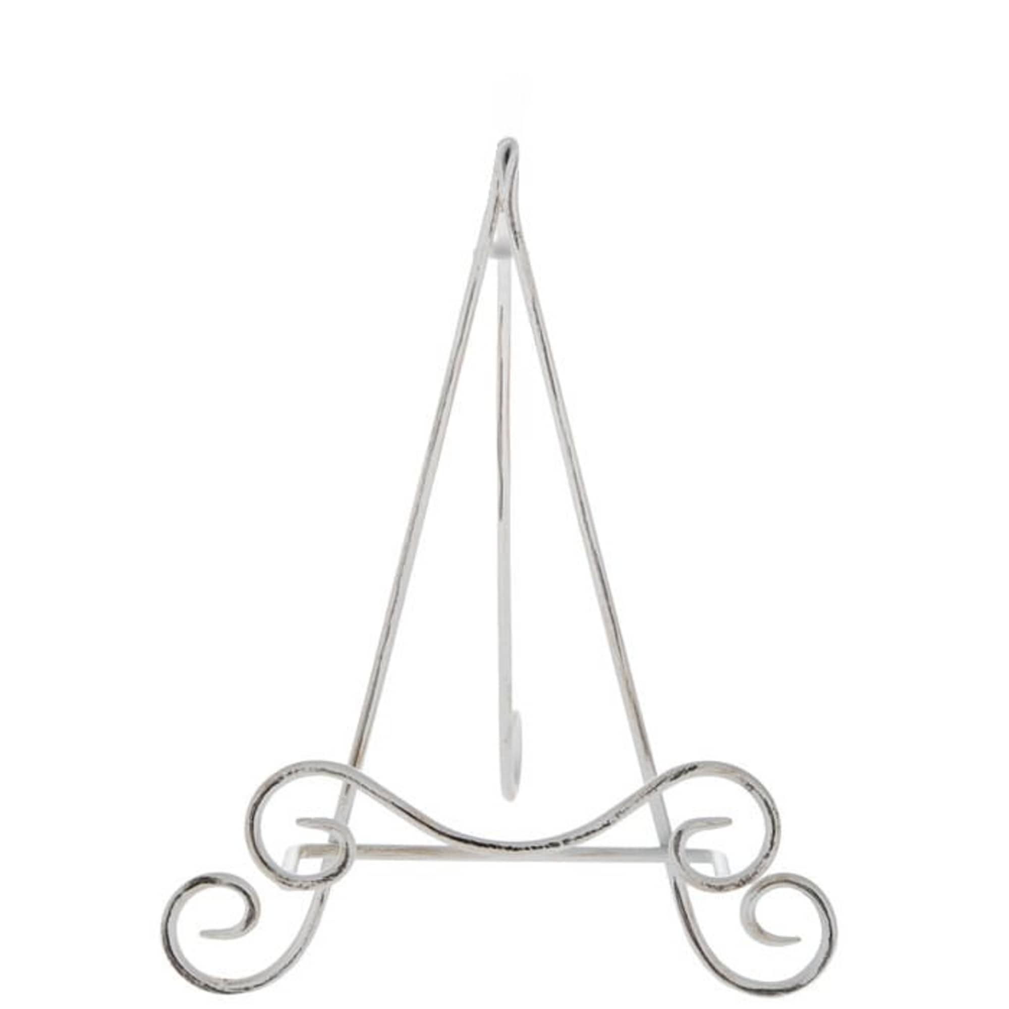Decorative metal easel stand with curled feet on a white background