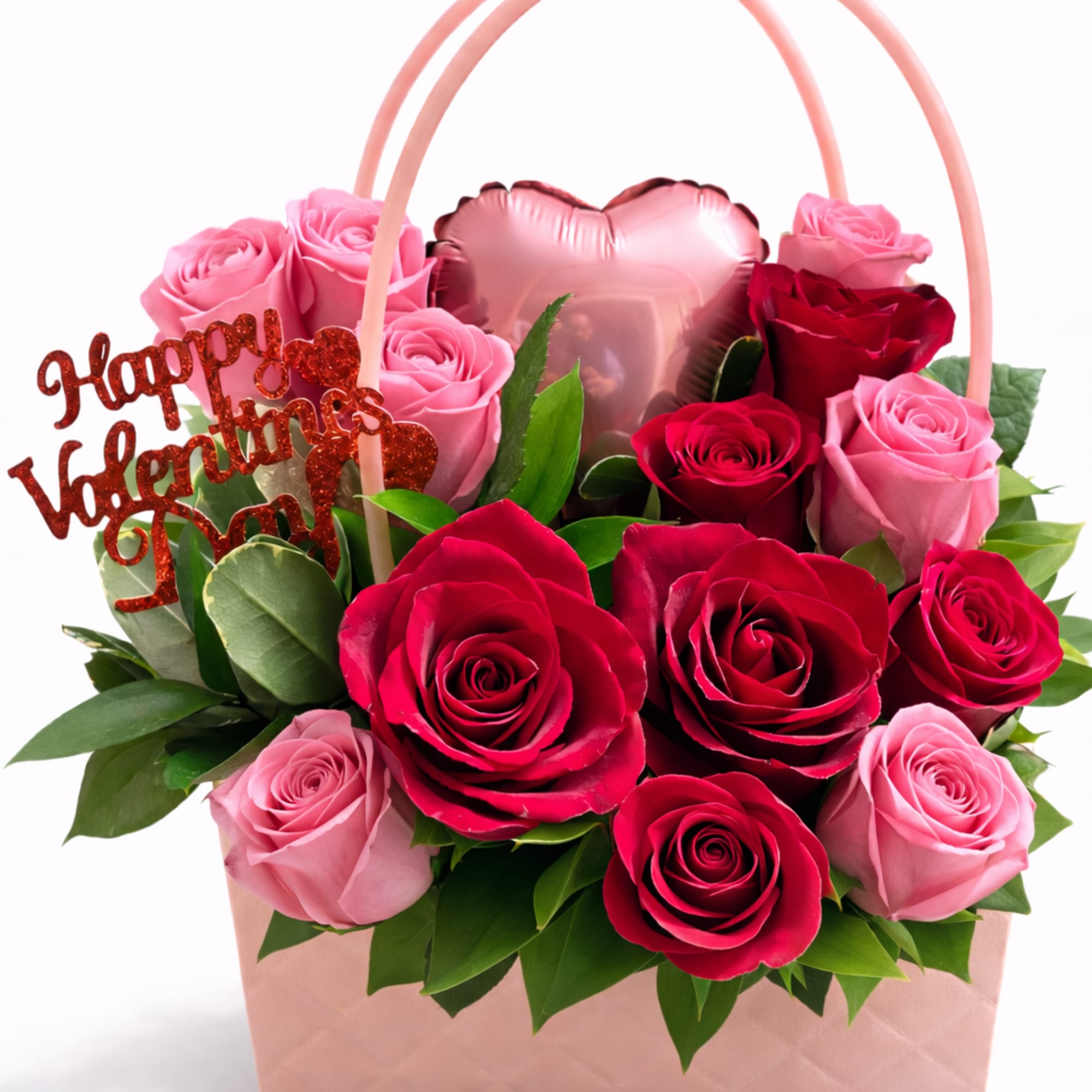 Pink and red roses in a blush gift bag with a heart balloon