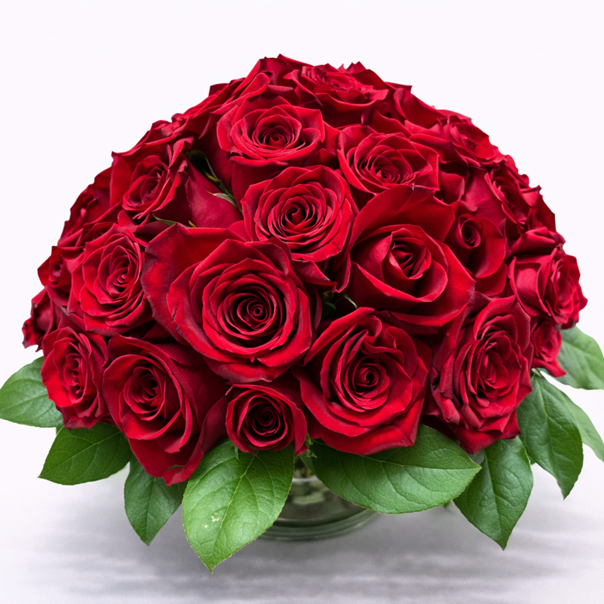 Round bouquet of red roses in a glass vase