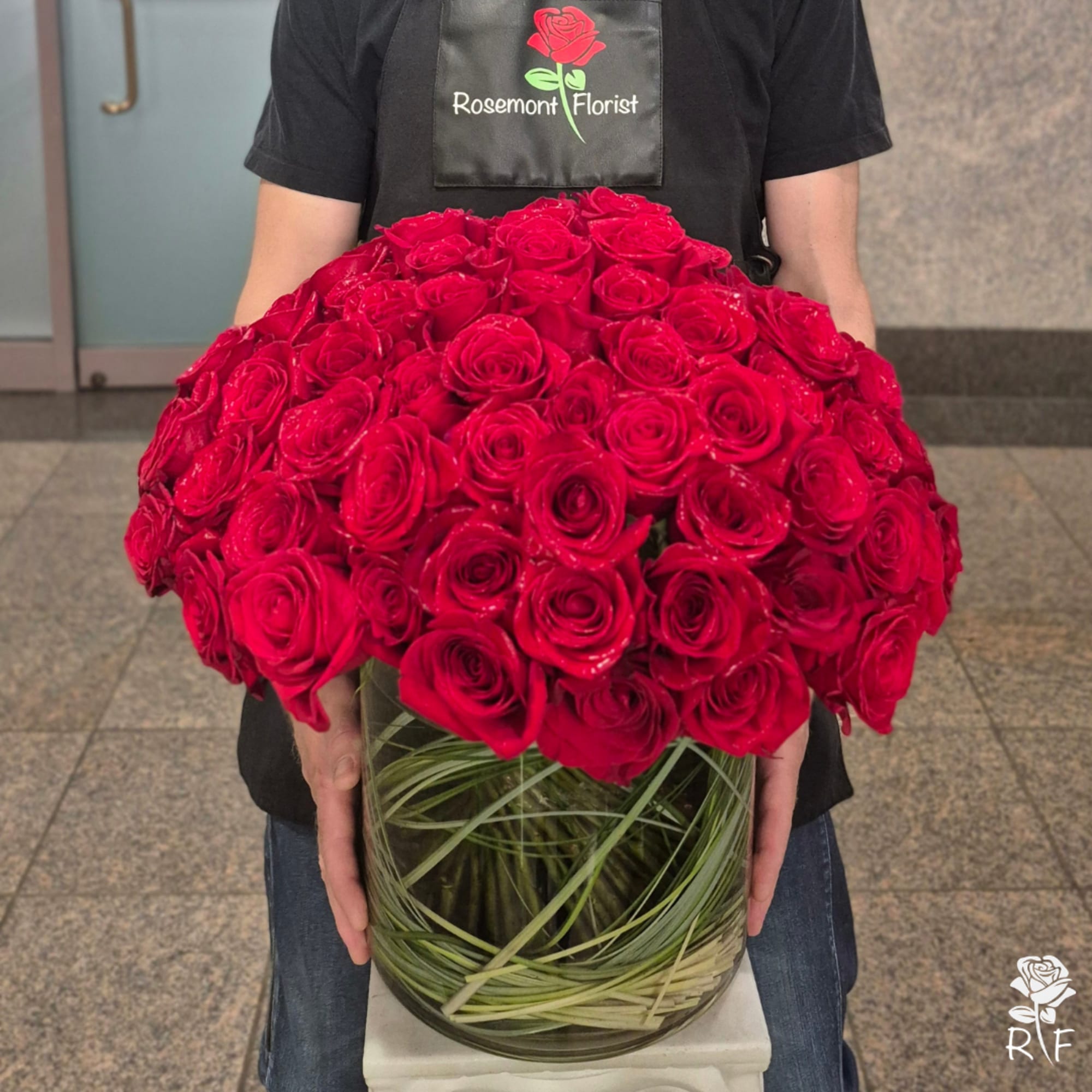 Large bouquet of red roses in a glass vase